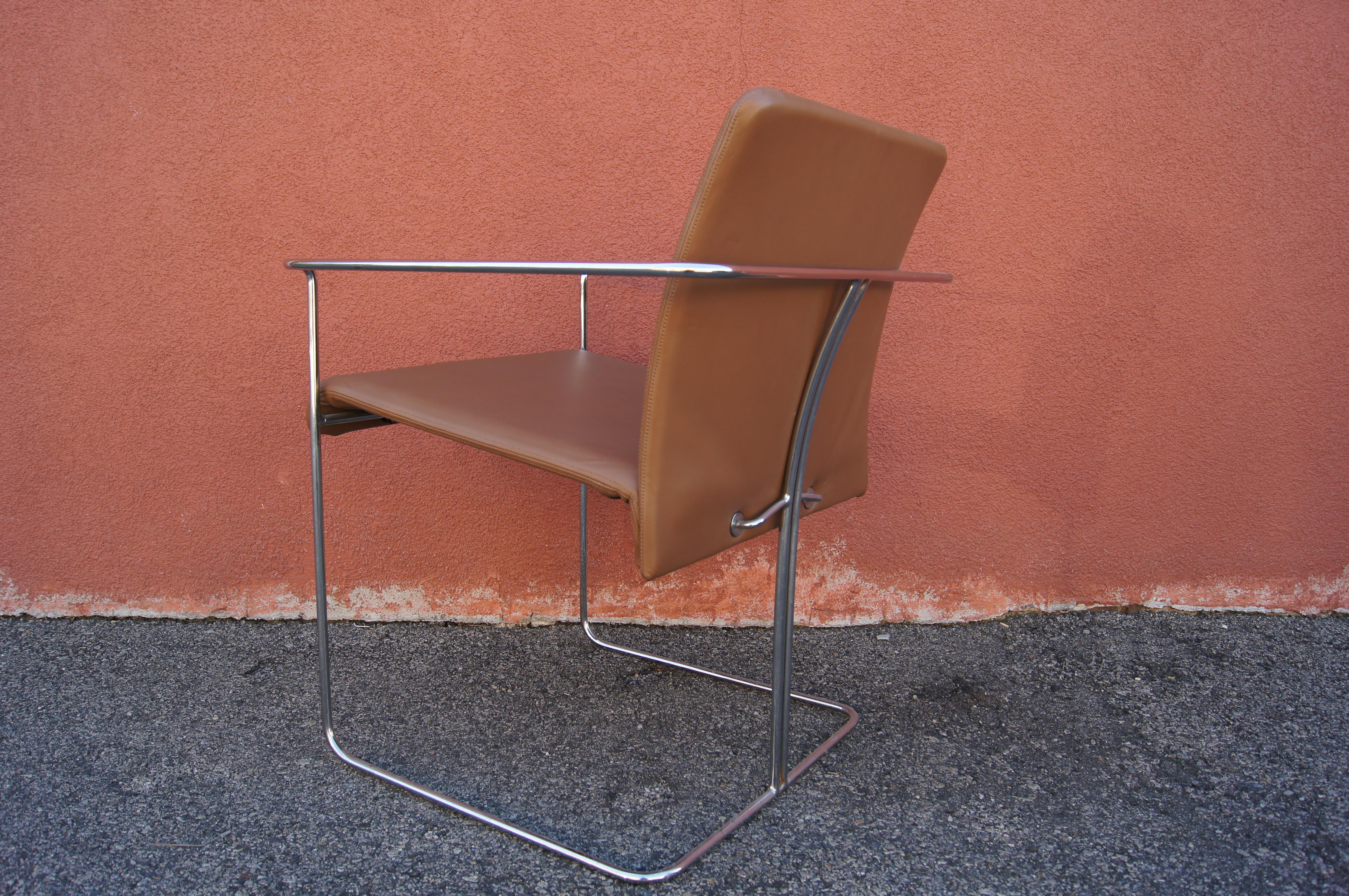 Ernesto Radaelli's P15 armchair for Saporiti features a slim frame of chromed steel rods with an angled back rest. This set of four has caramel-colored leather seats.