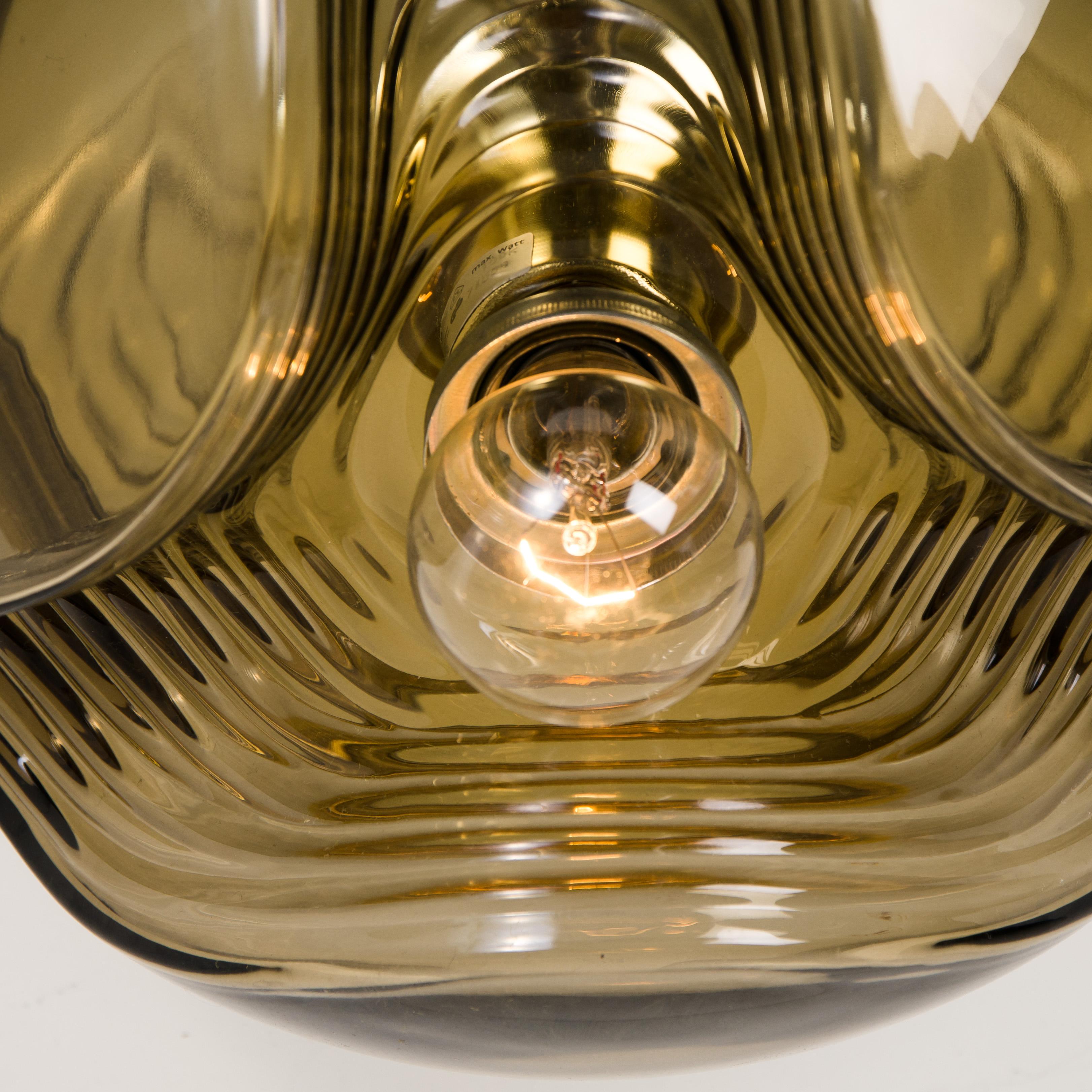 A special set of round Biomorphic smoked glass light fixtures designed by Koch & Lowy for Peill & Putzler, manufactured in Germany, circa 1970s.These Peill & Putzler vintage wall lights become quickly design classics. 

The blown glass has a