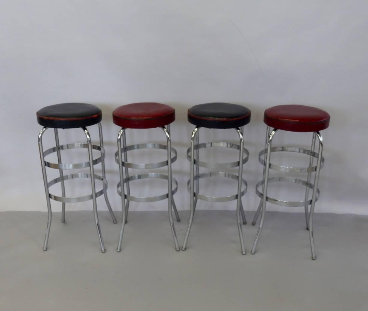Four Lloyd chrome bar stools attributed to KEM Weber. Tubular steel legs connected with flat 