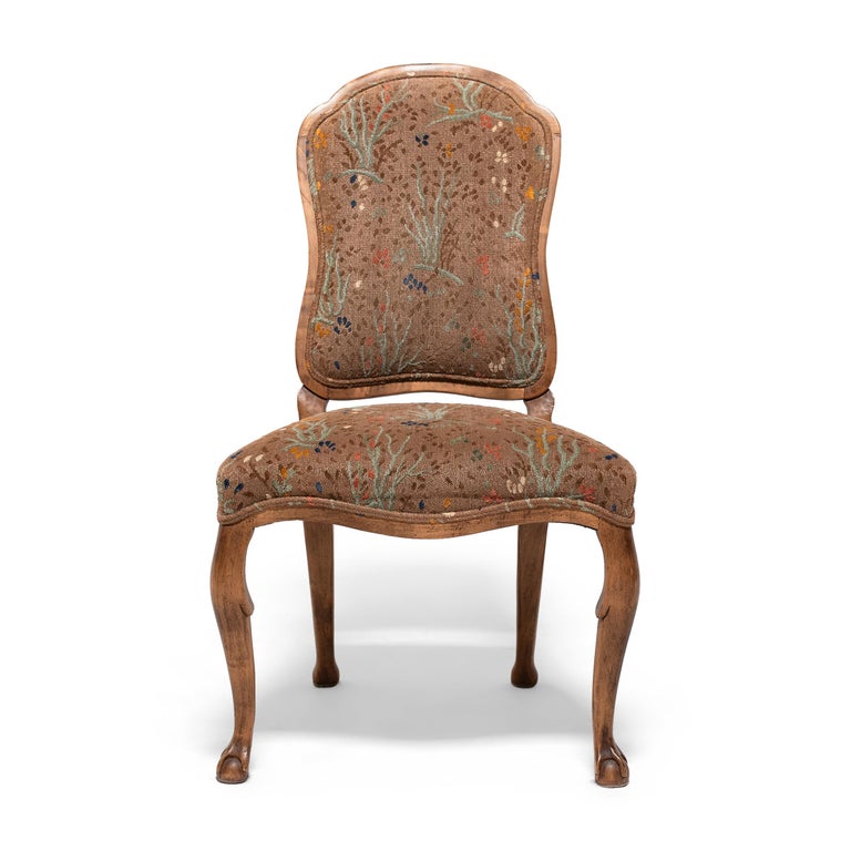 This set of four upholstered dining chairs wonderfully recreates the Louis XV style with sinuous fruitwood frames and nary a straight line in sight. Created by Minton-Spidell, this updated interpretation of the Classic Louis XV side chair is