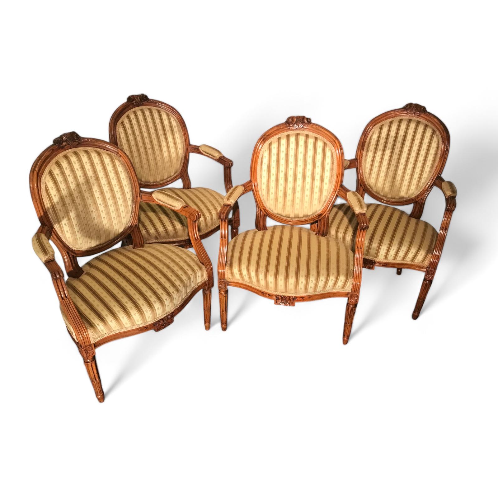 Dating back to 1780, this set of four Louis XVI armchairs exudes timeless elegance and classic sophistication. Each chair features an oval-shaped back adorned with intricate floral motifs at the center, evoking the charm of the Louis XVI era. The