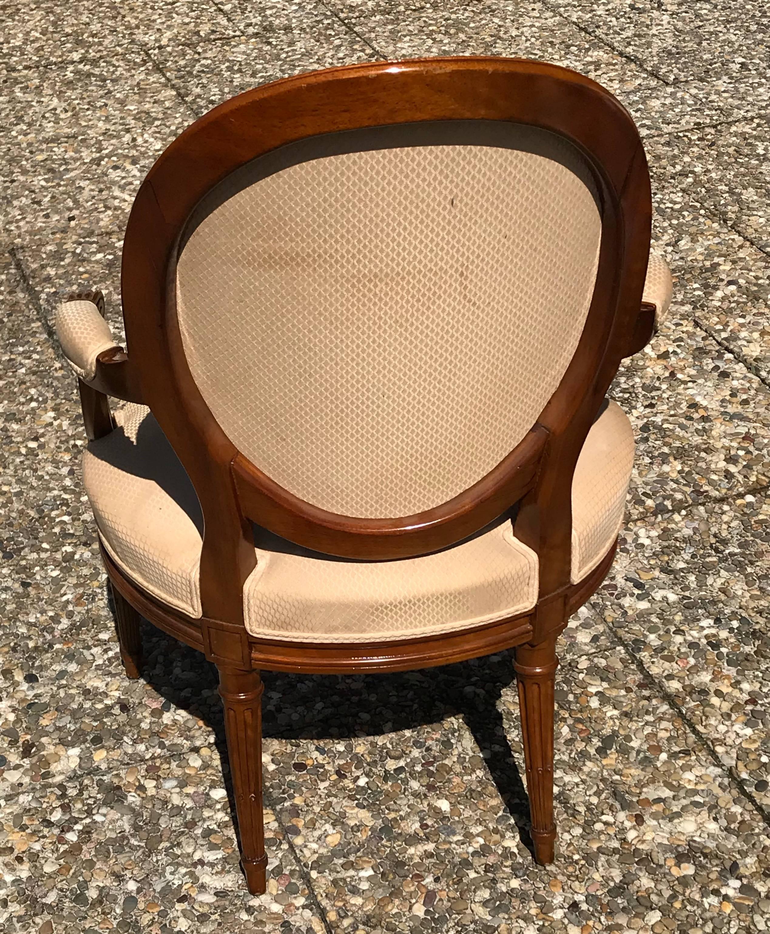 A set of four Louis XVI fauteuils, France beginning of 19th century, walnut. Nicely carved details. In original condition. The armchairs will be shipped from Germany. Shipping costs to Boston are included.