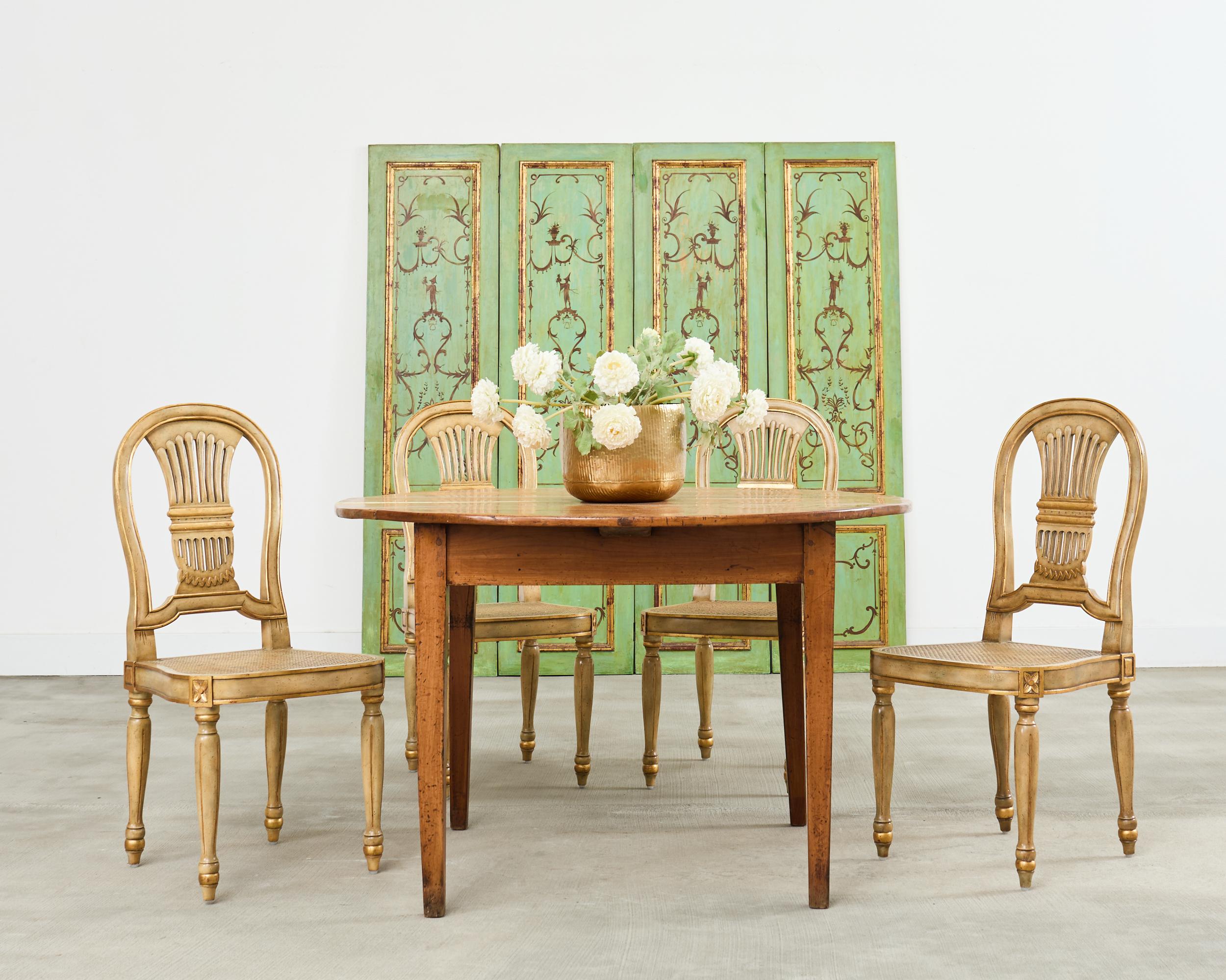 Gorgeous set of four labeled French painted dining chairs by Maitland-Smith. The chairs feature a classic Louis XVI style horseshoe (Fer á Cheval) or balloon (Montgolfier) back design on the splat. The painted frames have an intentionally,