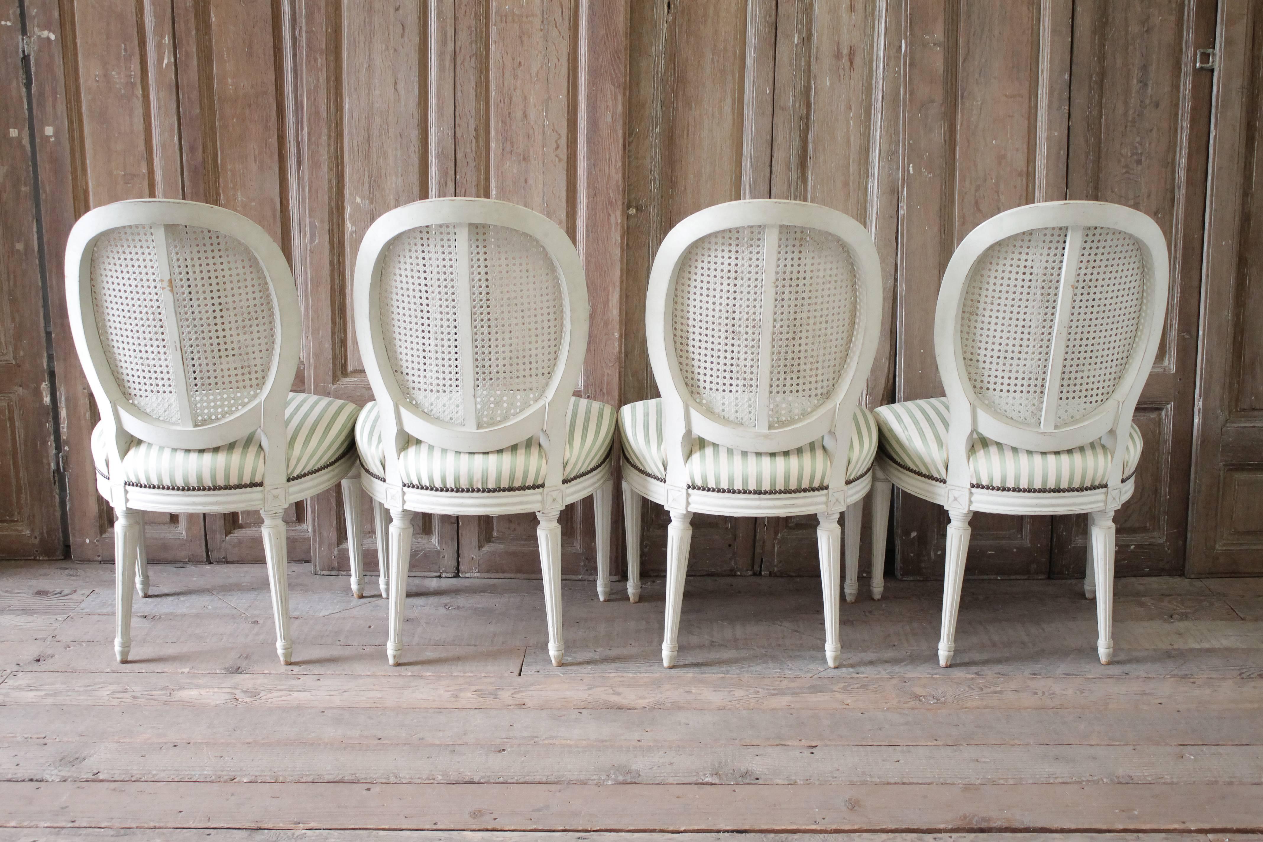 Set of Four Louis XVI Style French Painted Cane Back Dining Chairs 1