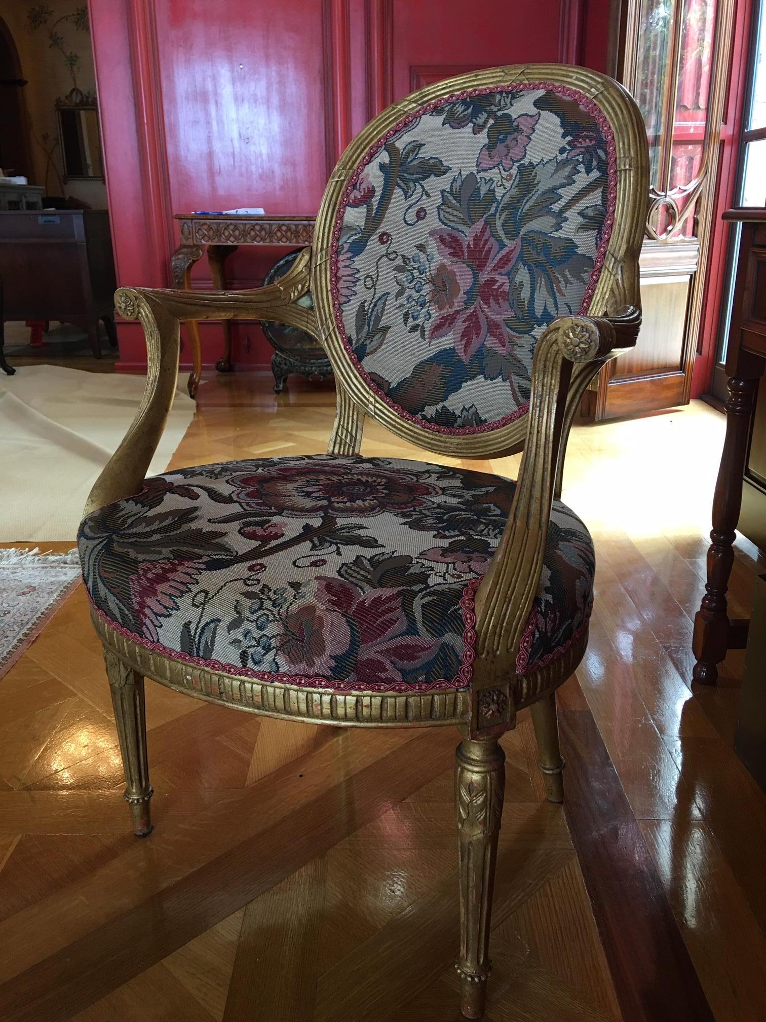 Set of four Louis XVI style gilded armchairs and reeded legs, 20th century.