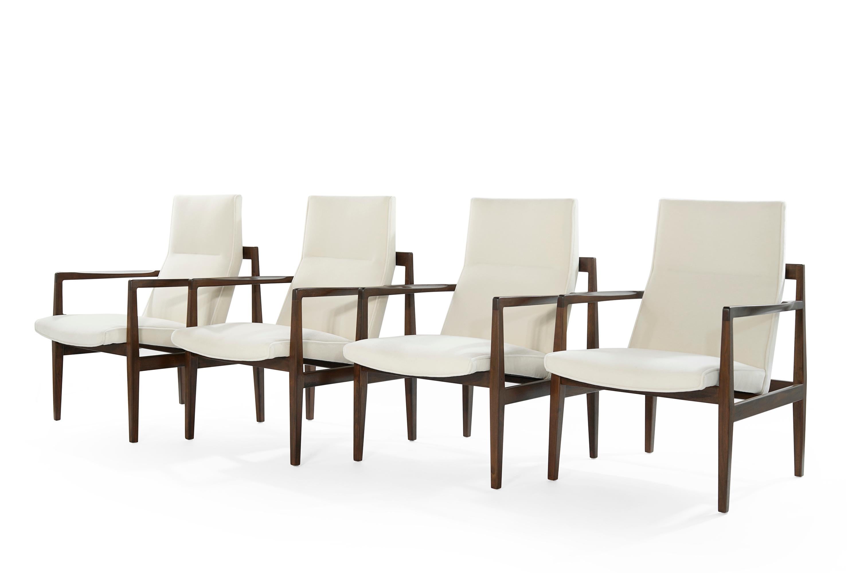 A set of four high-back lounge chairs designed by Jens Risom, featuring fully restored open-arm walnut frames, boasting clean, elegant lines from all angles. Newly upholstered in mohair by Holly Hunt. Priced as a set of four but also available in