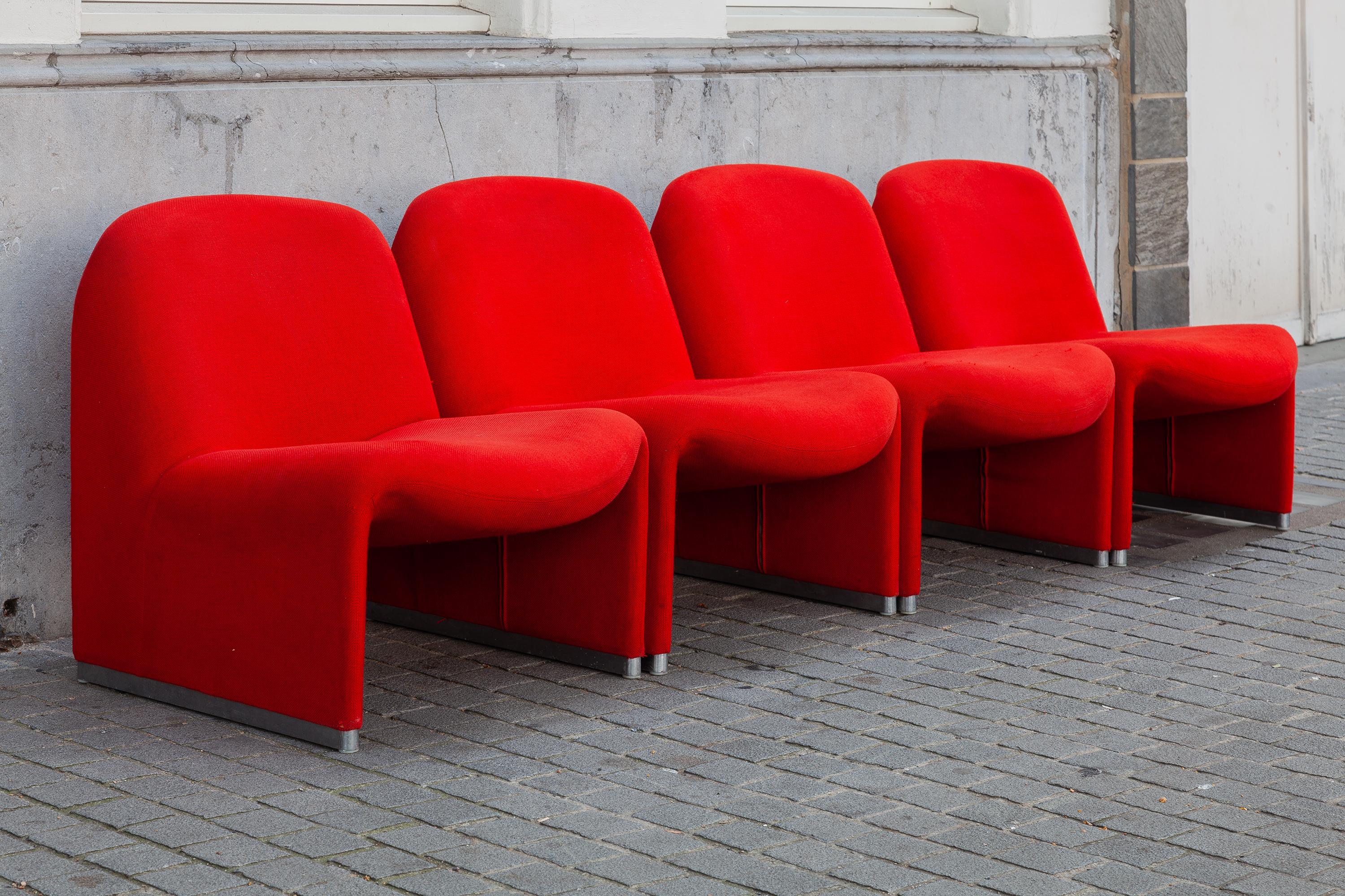 Set of 4 lounge “Alky” chairs designed by Giancarlo Piretti original Red wool upholstery. Aluminum frame and polished chrome foot rests. Beautiful organic curves reminiscent of Pierre Paulin designs. Produced by Castelli, 1972. Dimensions: 65 W x 70