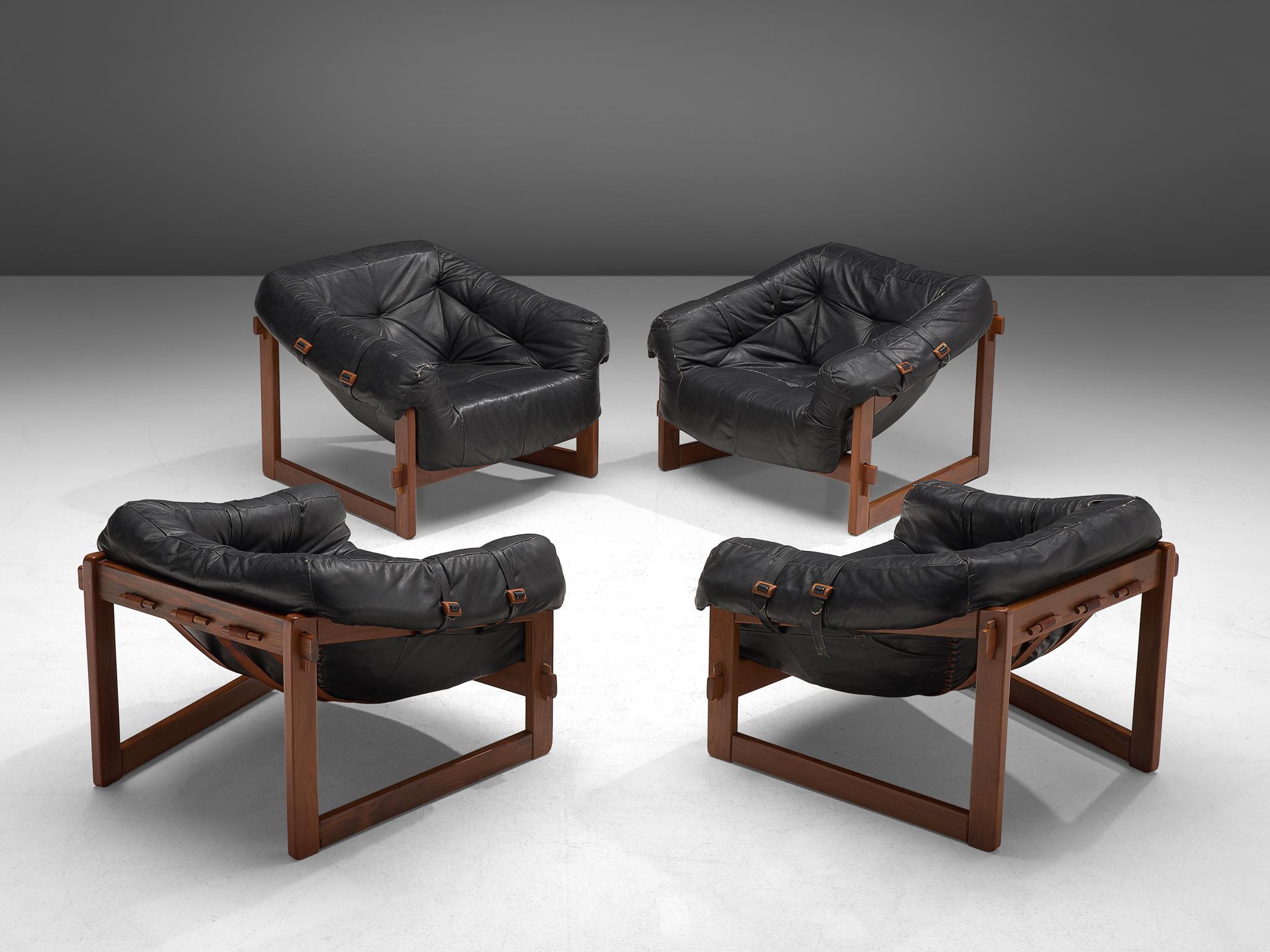 Percival Lafer, set of four lounge chairs, leather and Brazilian hardwood, Brazil, late 1960s.

Bulky and grand lounge chairs by Brazilian designer Percival Lafer. This set features a solid dark wooden base with brown leather straps spanned