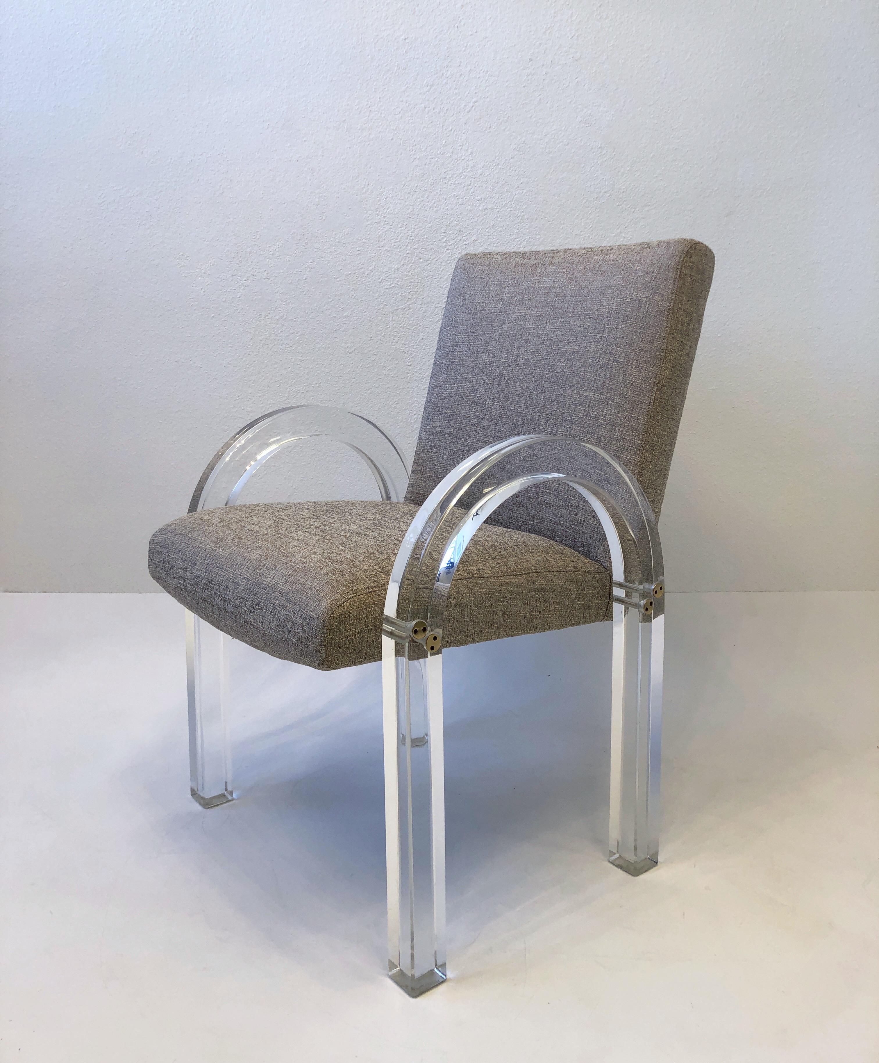 Set of four 1970’s ‘Waterfall’ dining chairs by renowned American designer Charles Hollis Jones. 
Newly recovered and the lucite has been professionally polished. 
Measurements: 23.25” wide, 27” deep, 34.5” high, 24.5” arm, 19.75” seat.