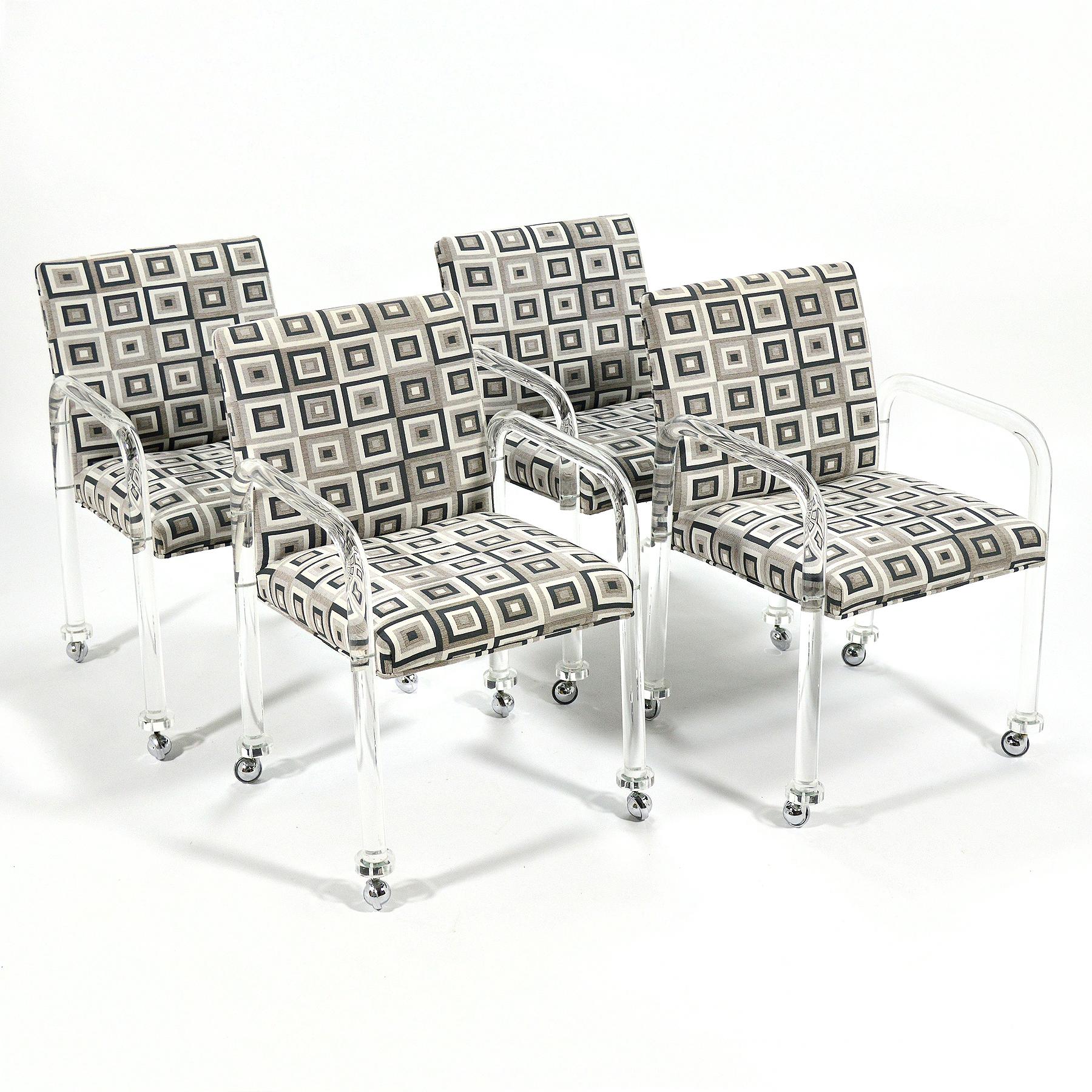 These handsome armchairs have tubular Lucite arms/ legs which support the upholstered seat/ back that features a fun geometric patterned fabric. Reminiscent of the work of Charles Hollis Jones, or Jeff Messerschmidt's 