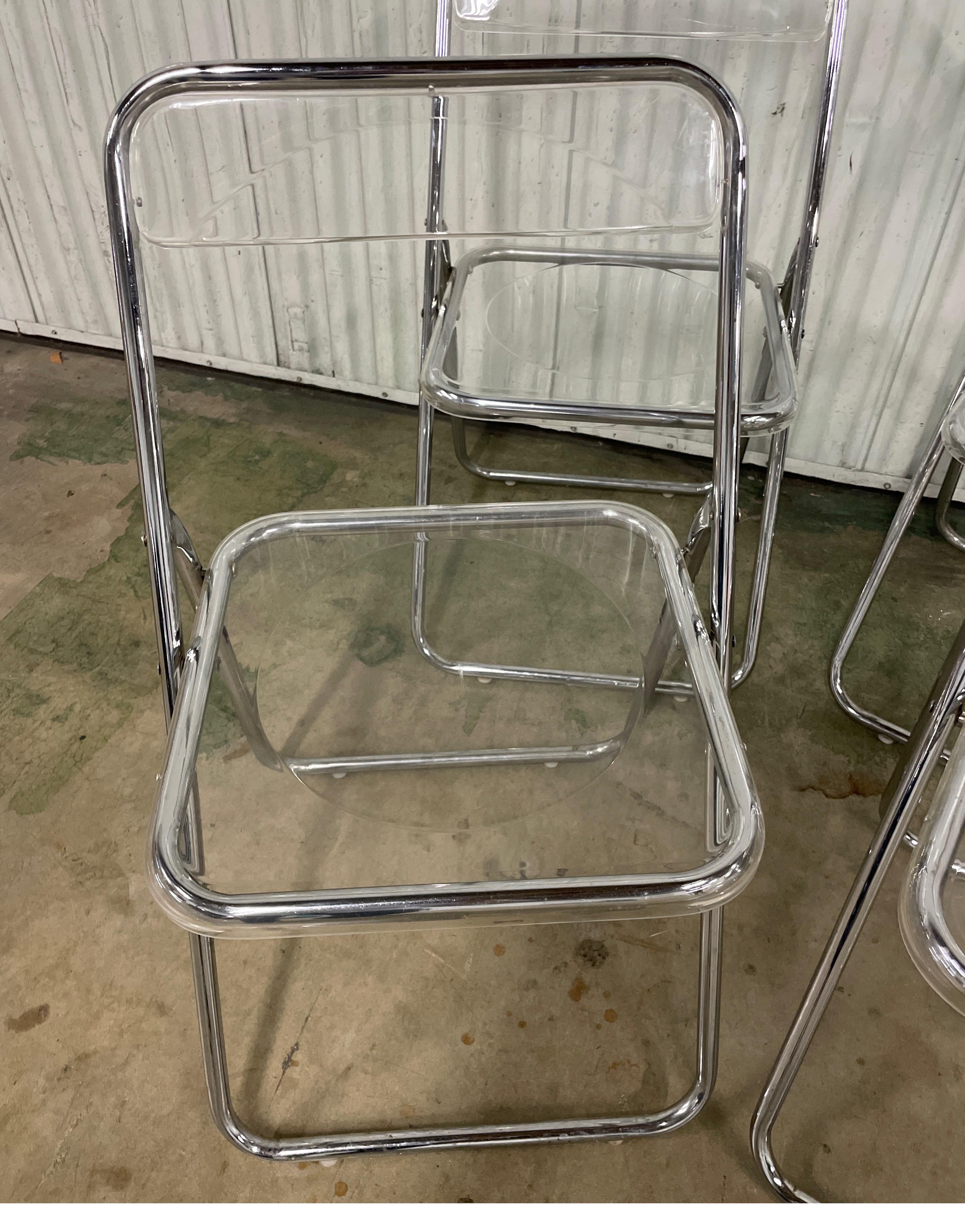 Very nice set of four mid century modern Lucite folding chairs. Great to have when you need that extra seating for your dinner party. Fold flat for storage.