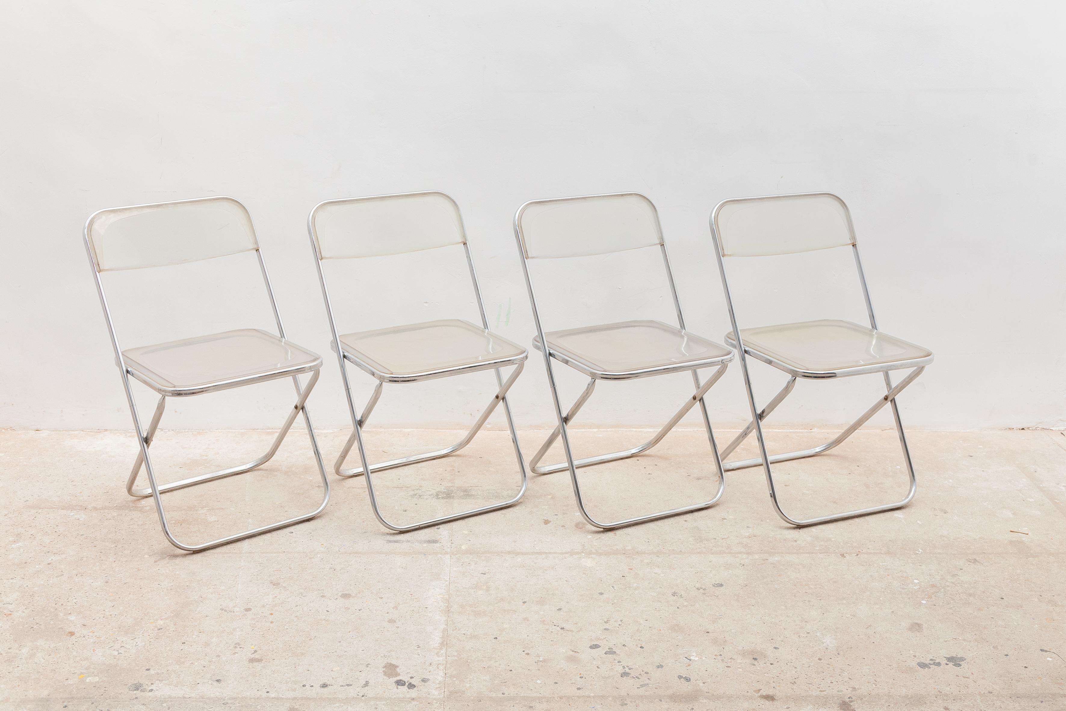Beautiful set of four Castelli folding chairs from the 1970s in the style of Giancarlo Piretti's Plia chairs, circa 1970's featured in chrome-plated steel, cast aluminum and ABS plastic al in a good vintage condition. Some scratches on the lucite.