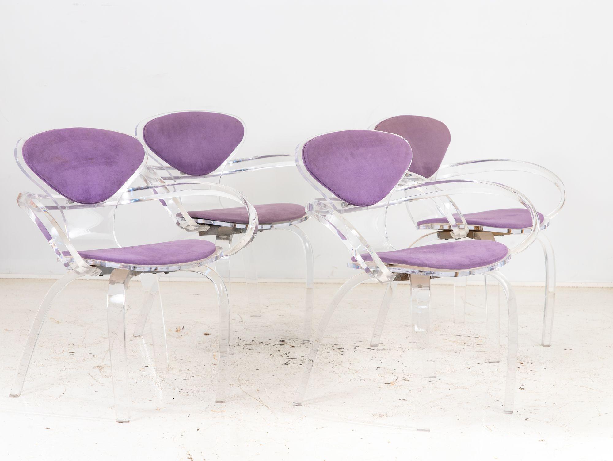 This set of four 1970s Lucite pretzel chairs, inspired by the iconic Cherner design, marries modern aesthetics with comfort. Their transparent Lucite frames create a captivating illusion of weightlessness, blending seamlessly into contemporary and