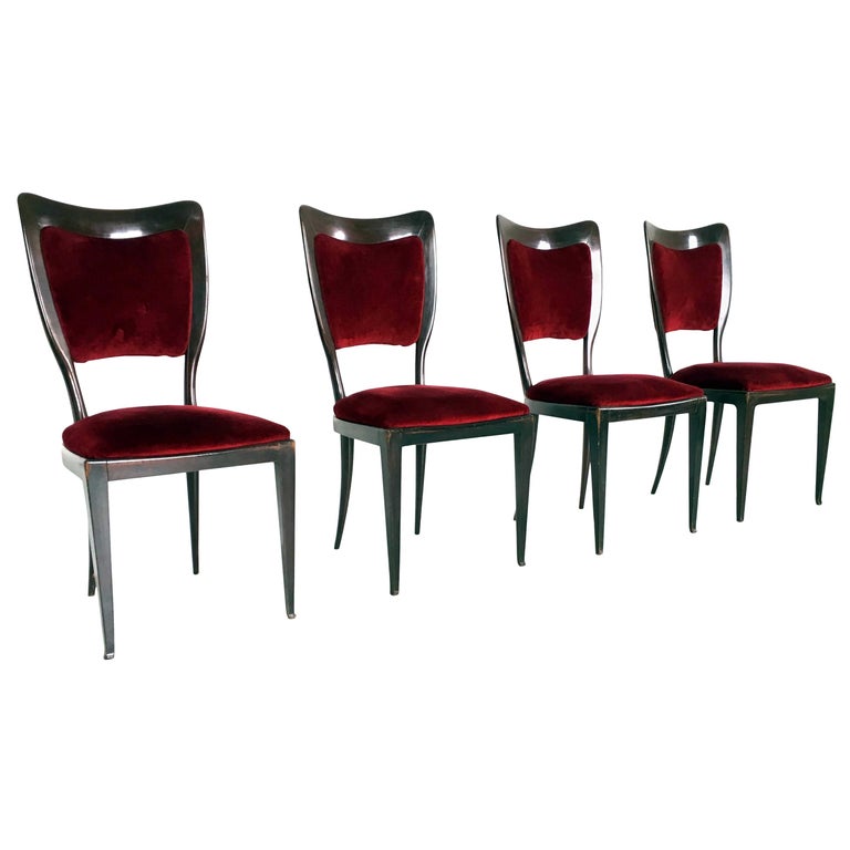 Made in Italy, 1950s.
These chairs feature a walnut frame and a crimson velvet upholstery. 
They are vintage, therefore they might show slight traces of use, but they can be considered as in good condition and ready to become a piece in a