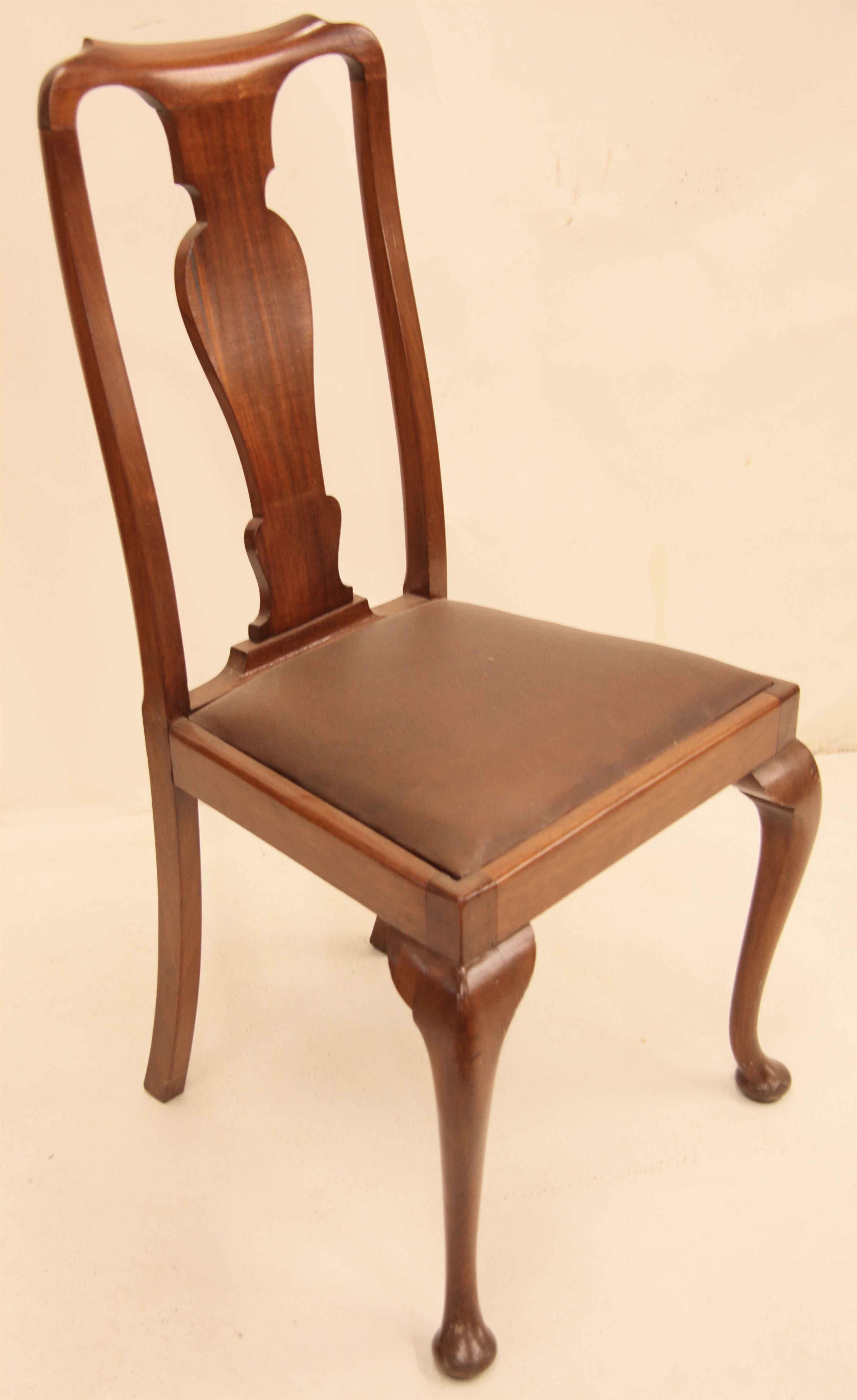 Set of four mahogany Queen Anne style chairs with a pleasant warm color and patina, typical vase shaped center splat, upholstered slip seats for easy recovering,  cabriole legs with well developed knee and pad feet.