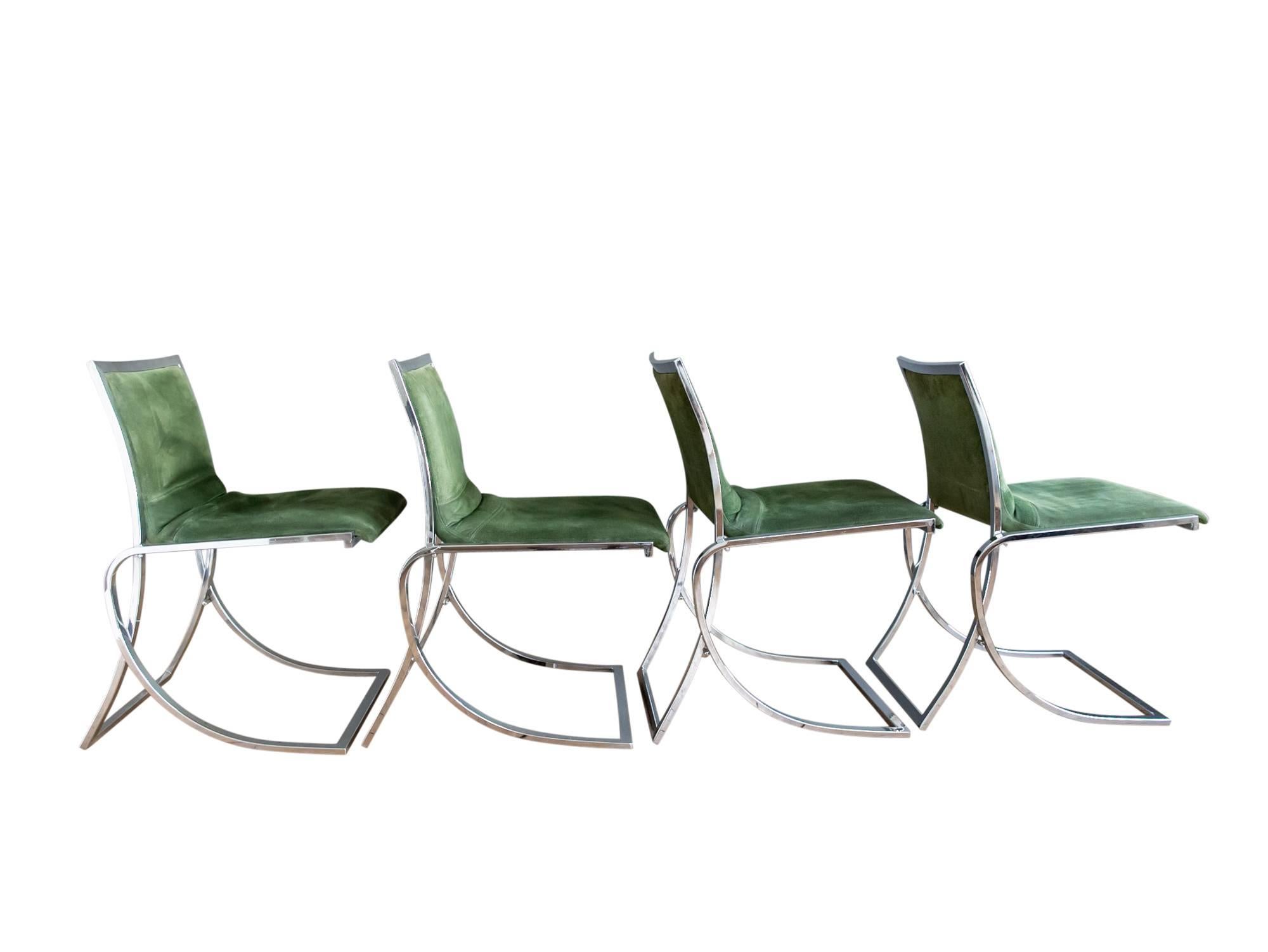 A stylish set of four chrome dining chairs by Maison Jansen, circa 1970s. Featuring heavy cantilevered frames with original emerald green suede upholstery. Well-constructed and in excellent vintage condition. Suede was recently conditioned and