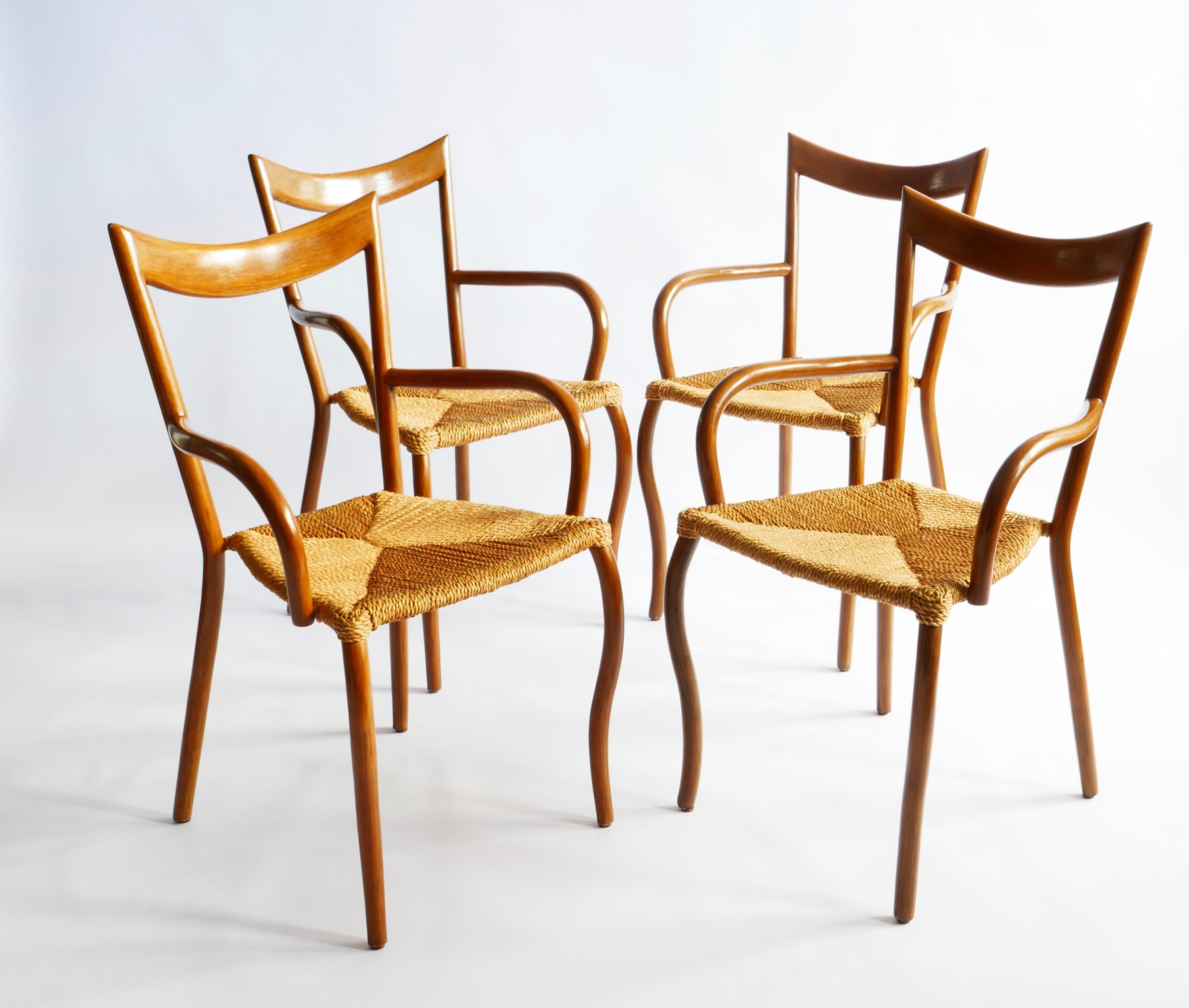 A set of four Manila arm chairs designed by Val Padilla for Jasper Conran.
A very light design for very strong chairs as the structure under the wood is in steel. Wood in walnut shade and seagrass seating. These chairs have won several design