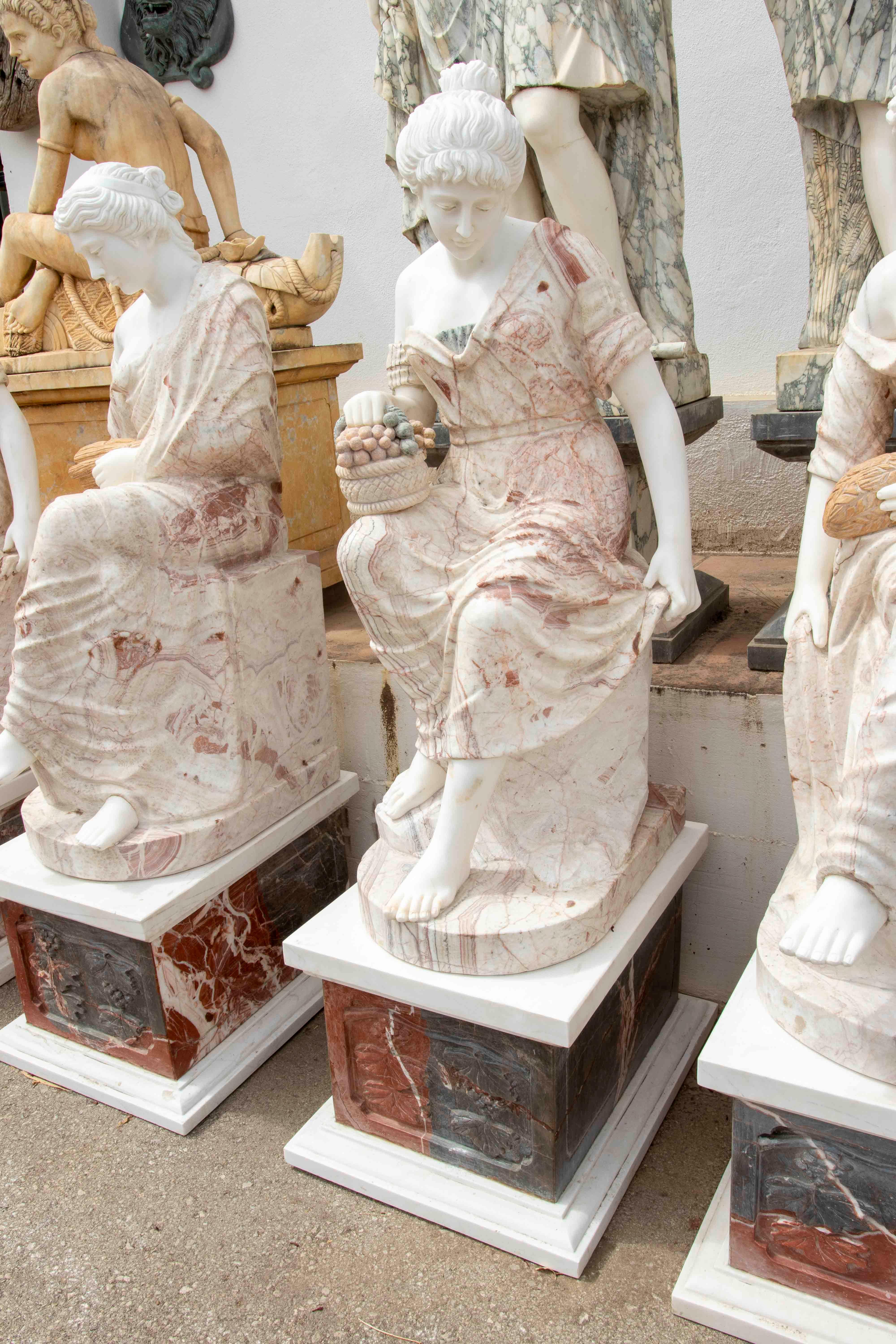 Hand-Carved Set of Four Marble Sculptures of Seated Classical Ladies with Pedestals For Sale