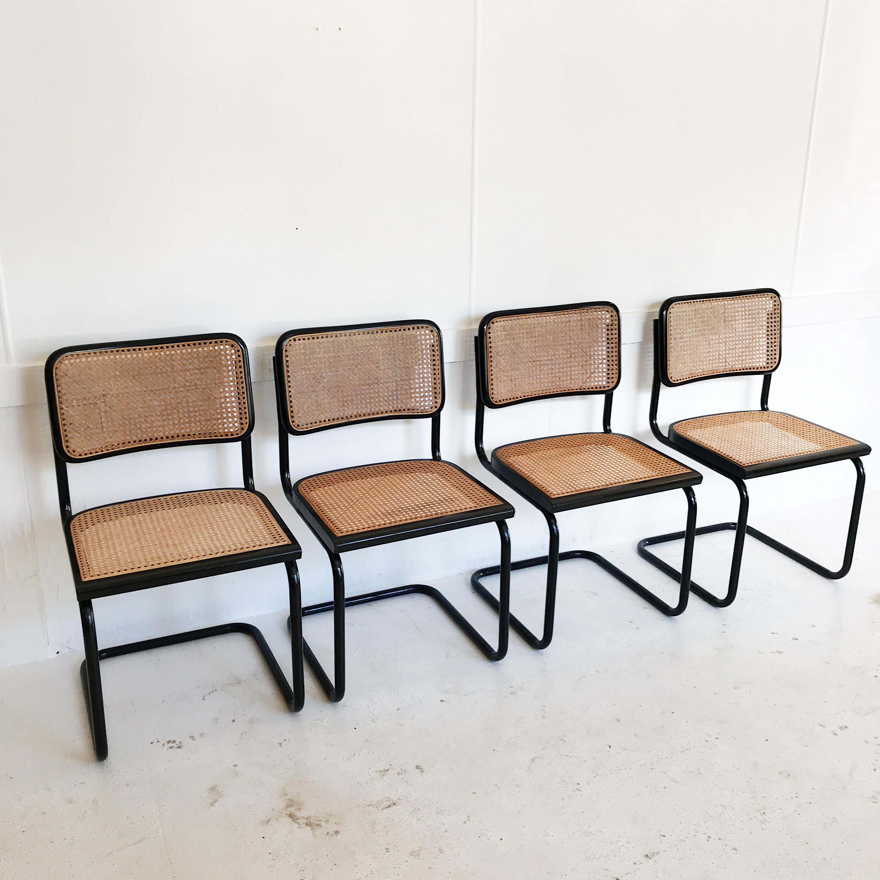 Original 1970s vintage Marcel Breuer complete dining set, in black. Features four Cesca chairs, with black tubular frame and cane intact, and a very heavy extendable black stained, timber veneer table.

Table dimensions are 137.5cm L (+ 60cm when