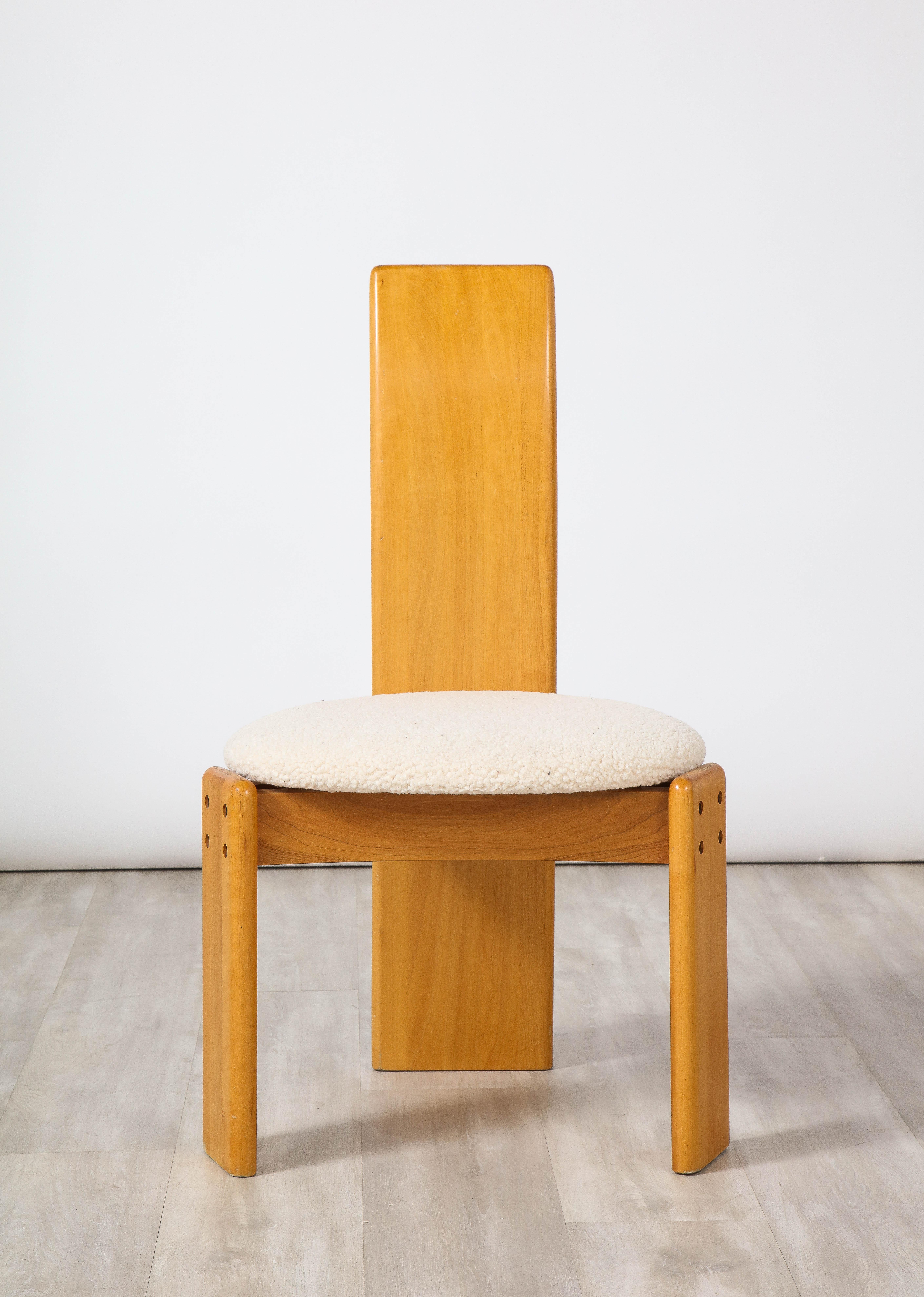 Set of four beautifully sculpted maple wood and boucle dining chairs designed by Afra and Tobia Scarpa. The backrest is elegantly narrow and reaches down to the floor, with a triangular base which supports the circular seat, newly upholstered in a