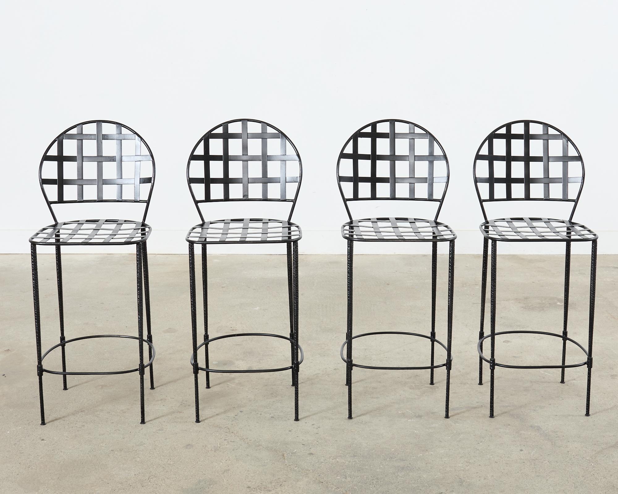 Distinctive set of four iron counter height barstools made in the manner and style of Mario Papperzini for John Salterini mid-century modern designs. The Amalfi stools have an iconic lattice metal strap neoclassical style on the seat and back. The