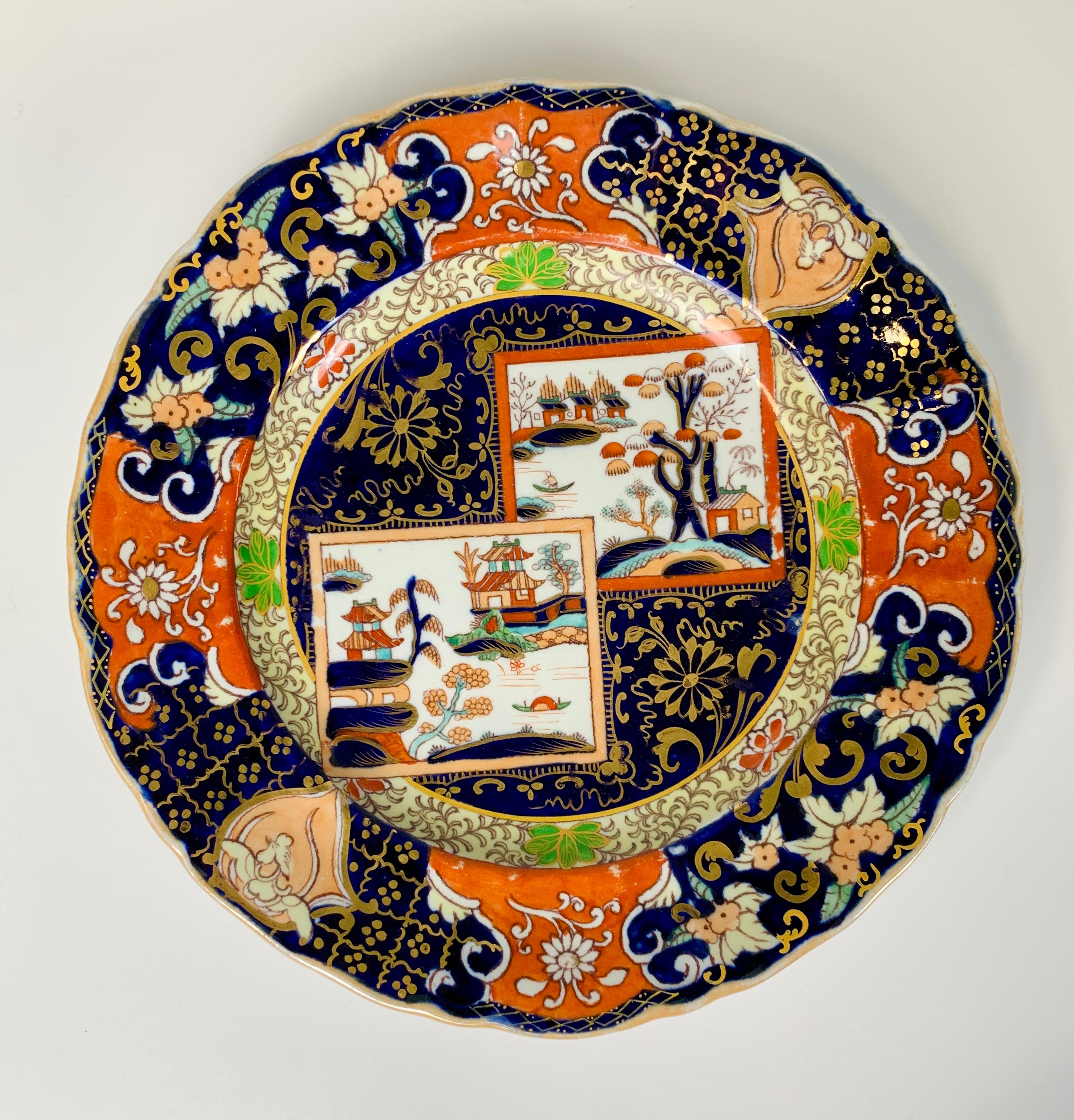A set of four Mason's ironstone plates made in England 1834-1842. The colors are vibrant; deep cobalt blue and bright orange. They are beautifully decorated with floral designs of peach-colored and white flowers and turquoise leaves.
In the center