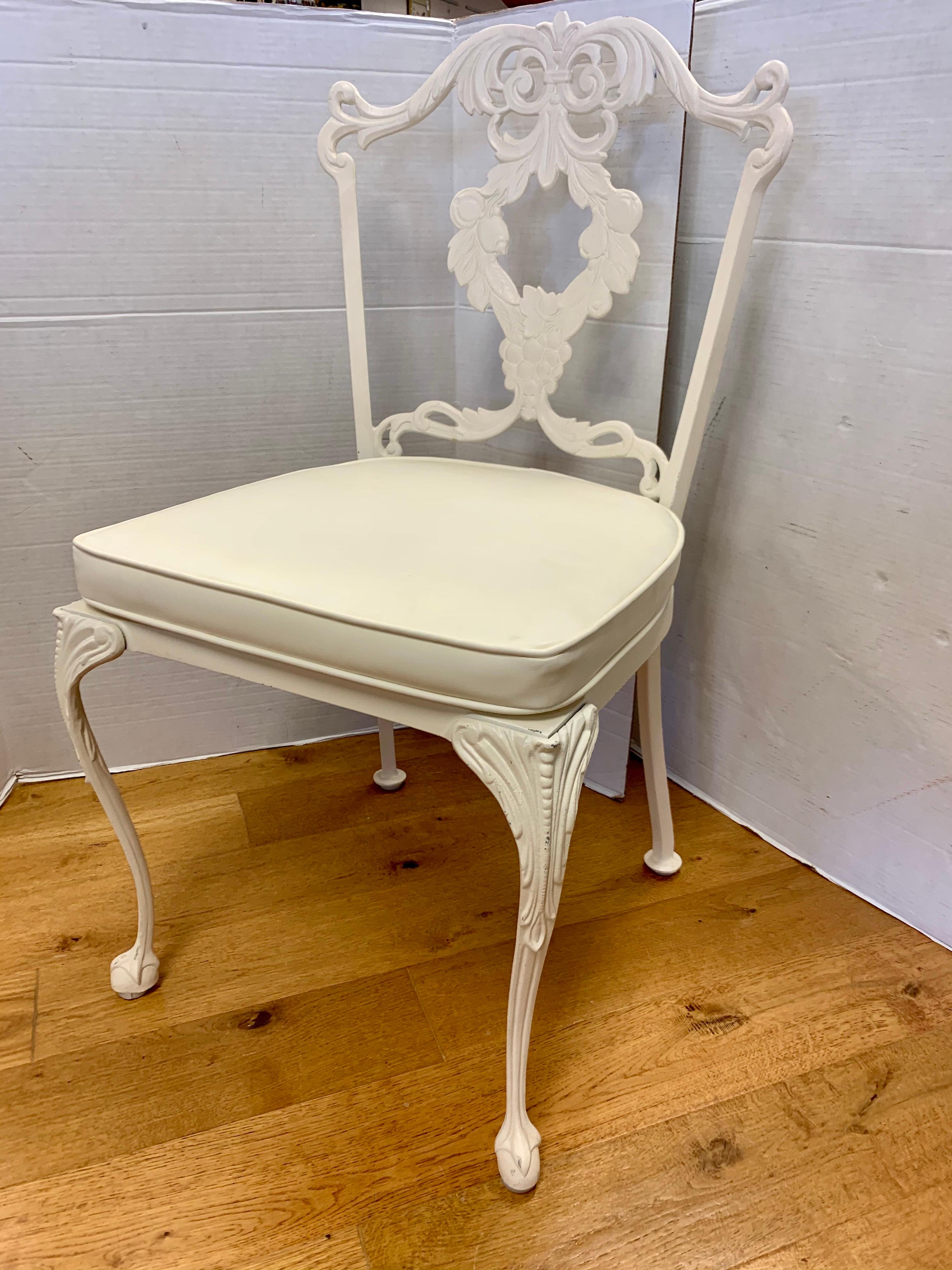 Set of four cast aluminum and white enameled French regency style dining chairs. Fresh white enamel over finely cast aluminum for which Molla was renowned. Ultra rare.