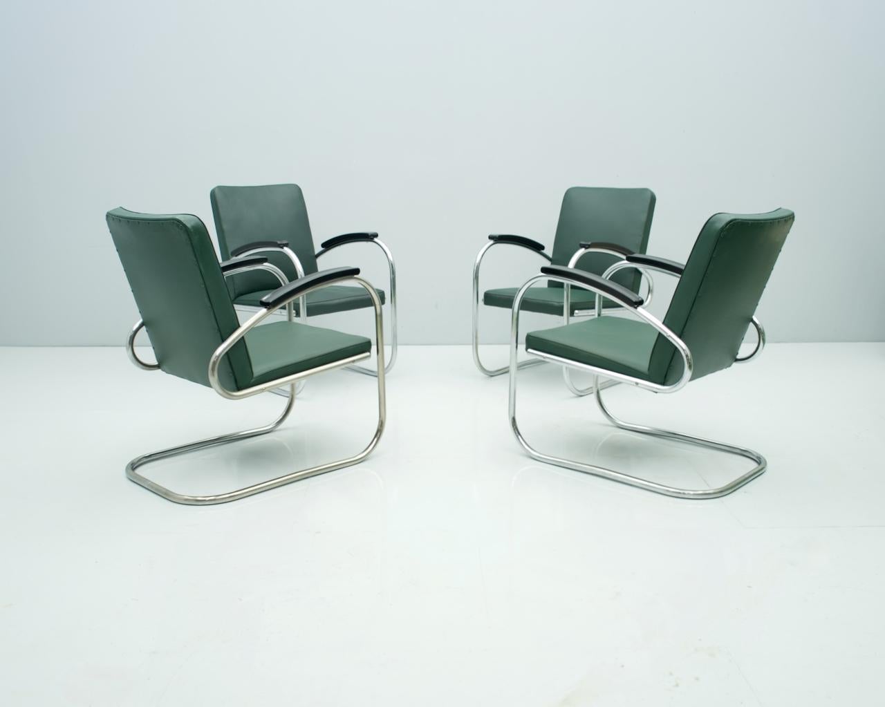 Rare set of four steel tube lounge chairs model RS 7 by Mauser Waldeck Germany, design 1935.
All chairs are in their original condition. Only minor repairs were made. The beechwood armrests were repainted black and the green color of the original