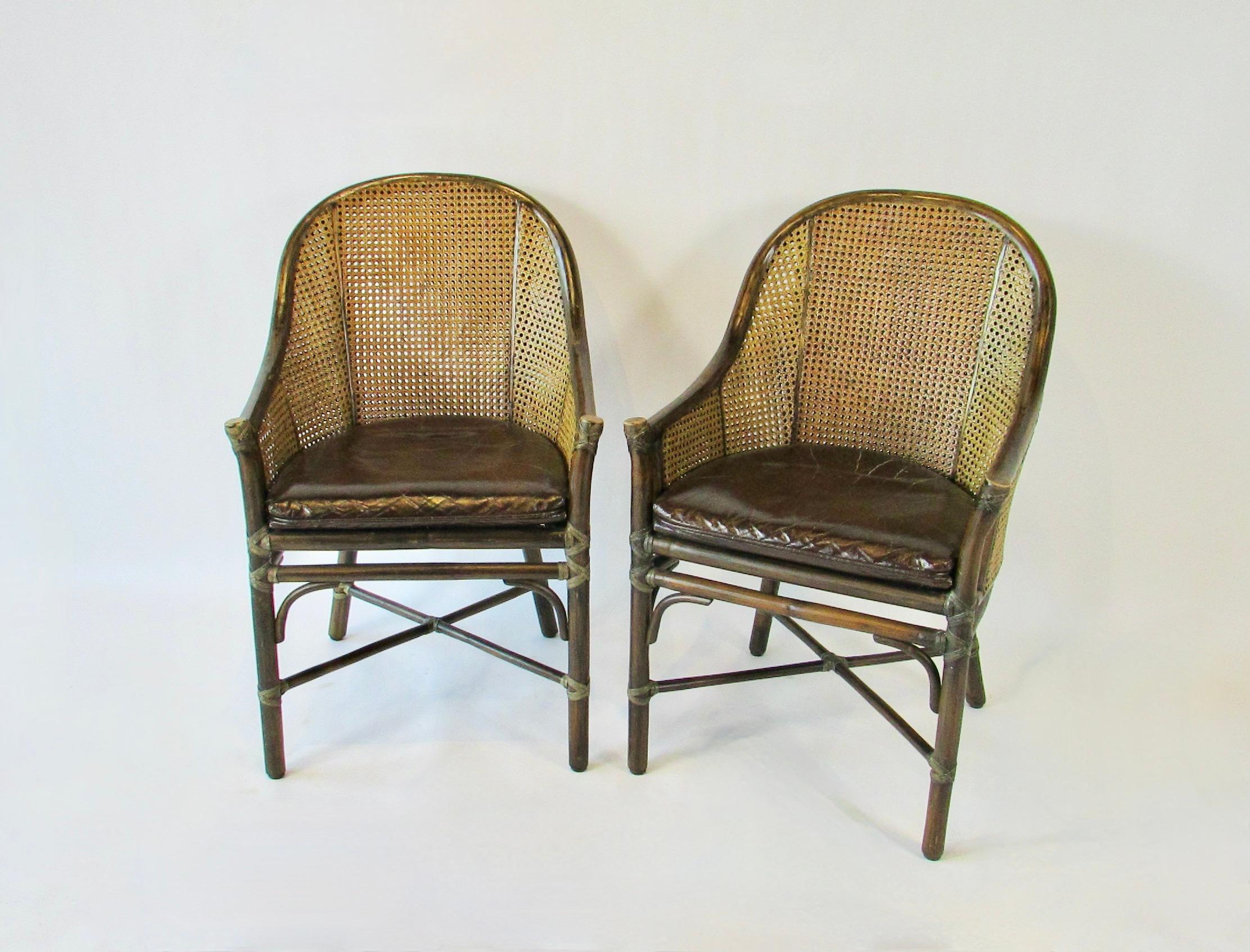 Set 4 Belden  dining chairs by Elinor McGuire. San Francisco, USA,  
California coast  modern style . Barrel back form of thick rattan or bamboo frames  inset with classic cane on the back and sides. The elegant backrest supports a fitted leather