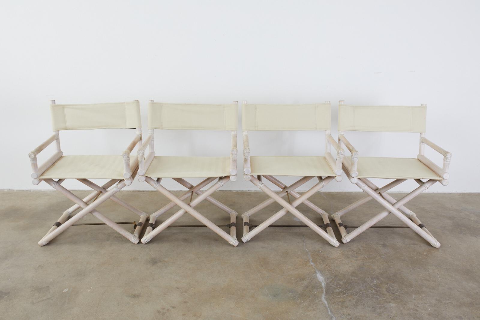 Rare set of four midcentury Campaign-style directors chairs by Leonard Linden for McGuire. The chairs feature a whitewashed or Cerused finish on the oak. Embellished with leather rawhide laces on the exposed joints and patinated brass stretchers on