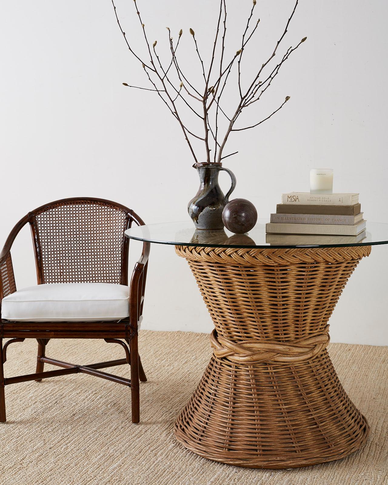 Handsome set of four rattan and cane horseshoe lounge chairs or club chairs. Classic mid-century style made by McGuire featuring a barrel-back form with cane inserts. The bamboo rattan frames have leather rawhide laces on the exposed joints and
