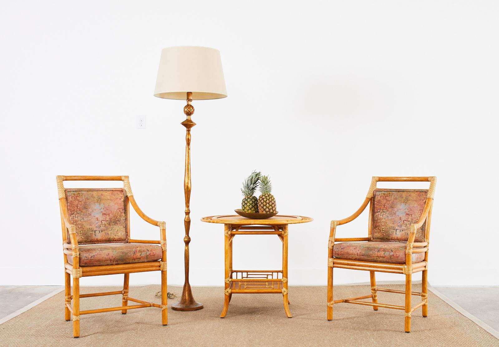 Gorgeous set of four dining armchairs made by McGuire model # MCM598. The chairs feature the iconic target design back designed by John McGuire with an optional ebonized accent ring on the target. Made in the California organic modern style with a