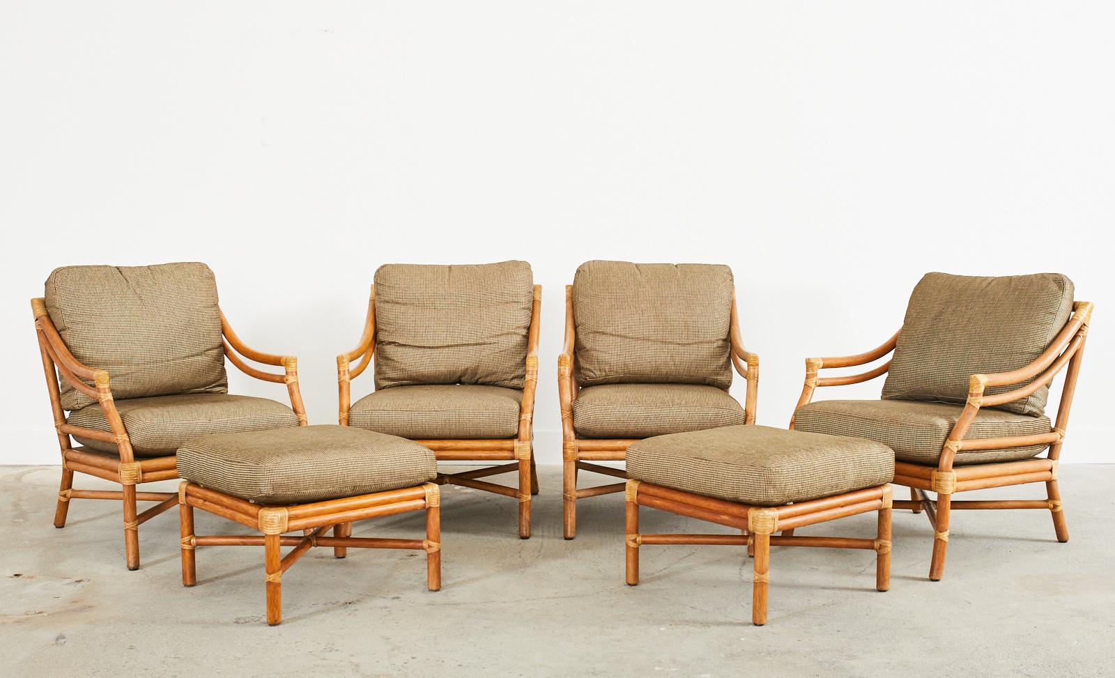 Iconic set of four McGuire rattan lounge chairs or armchairs and two ottomans. Model number MCA43 features a large, low-slung rattan frame having the famous target design back splat. The back is conjoined to gracefully curved double arms attached to