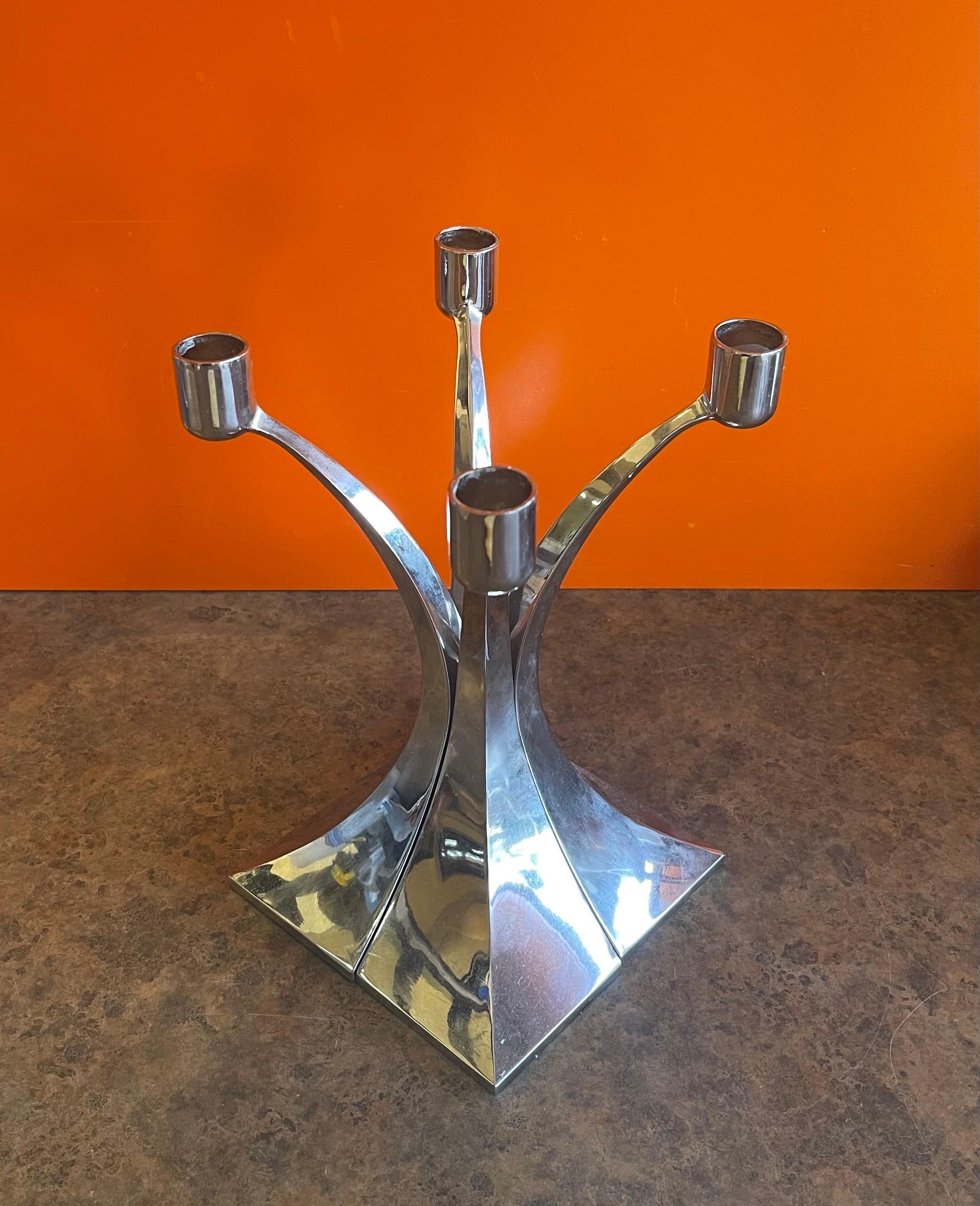 Set of four MCM chrome candlesticks that can be positioned in a number of configurations to make some very cool candleabras. Beautiful arched design on these solid polished chrome-plated steel pieces with 1