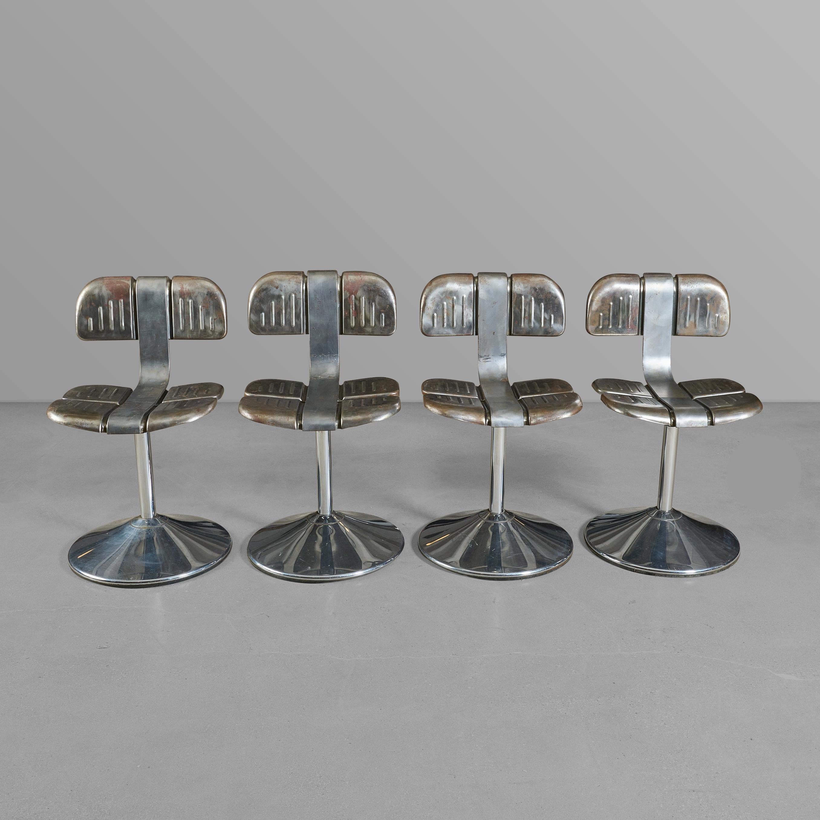 Set of four metal chairs with great design. Comfy, and they swivel as well.

