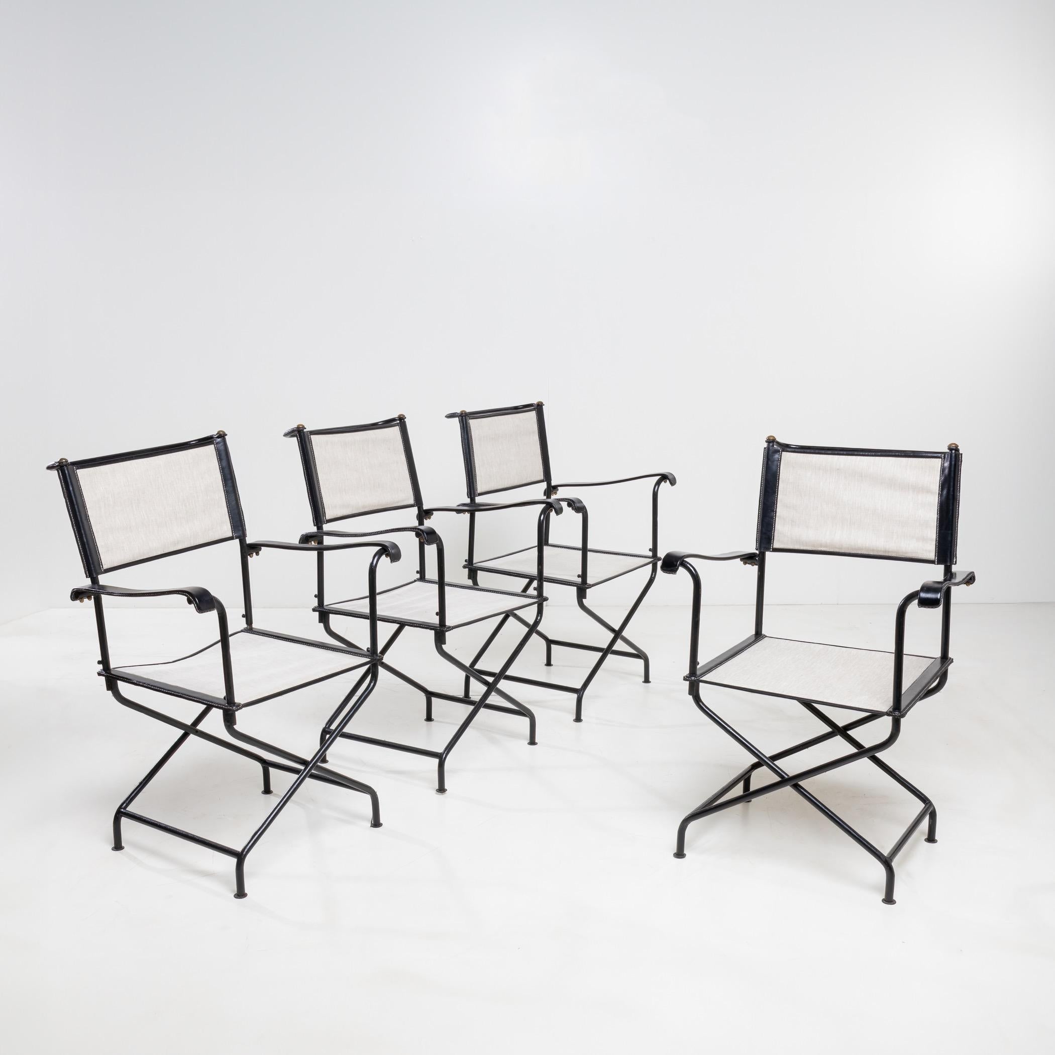 Set of four “director” armchairs, the structure and base in black forged steel by Jacques Adnet.
The seat and backrest in thick cotton with saddle stitched black leather accents.
The armrests and the large rear handle in saddle stitched black