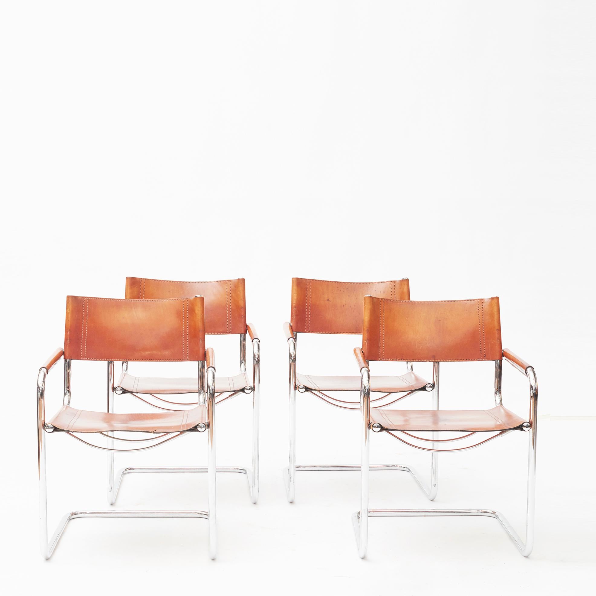 Set of four MG5 dining or office chairs designed by Mart Stam.
Tubular chrome frames with brown leather seating, backrest and armrest. Beautiful patina.
Italy, circa 1960-1970.

Can be sold in pairs.

Please note: One of the seats has been
