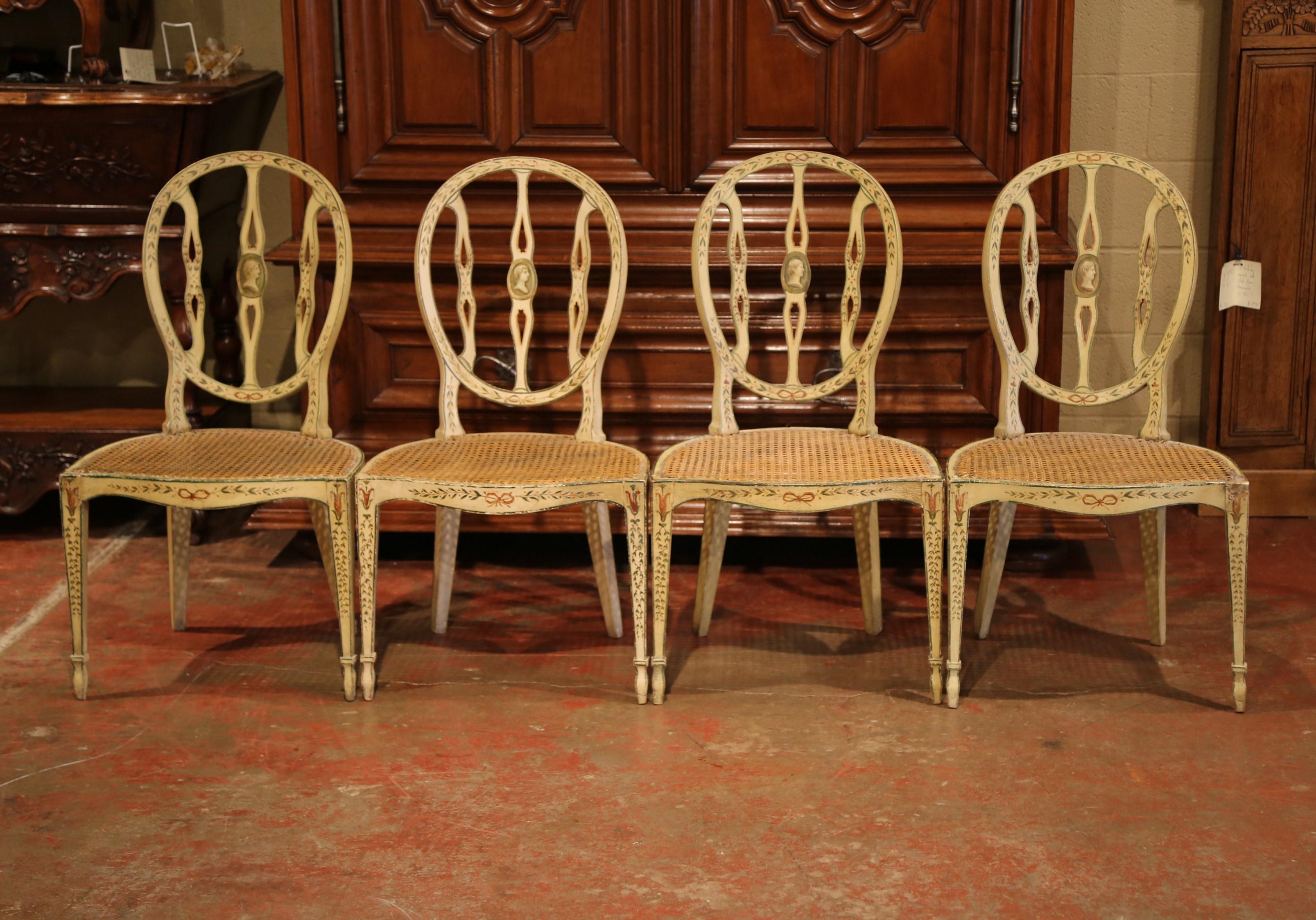 Use this colorful set of carved, antique chairs around a game table or breakfast table. Crafted in England, circa 1850, each delicate chair has tapered legs, and an oval back with a hand painted center medallion. The central medallion is further