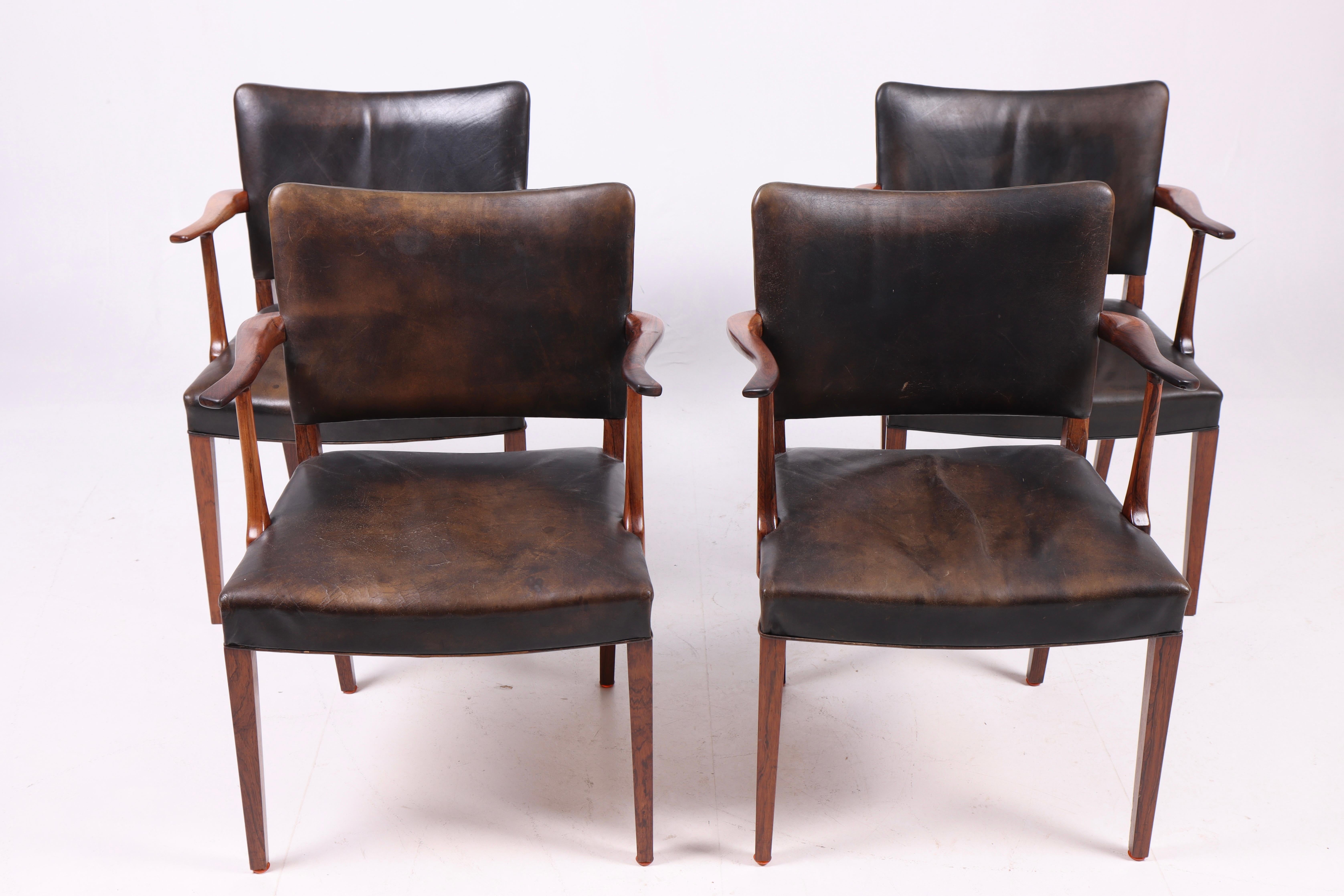 Set of four armchairs in rosewood and patinated leather designed and made by Rasmus Nielsen in 1950s. Made in Denmark. Great condition.