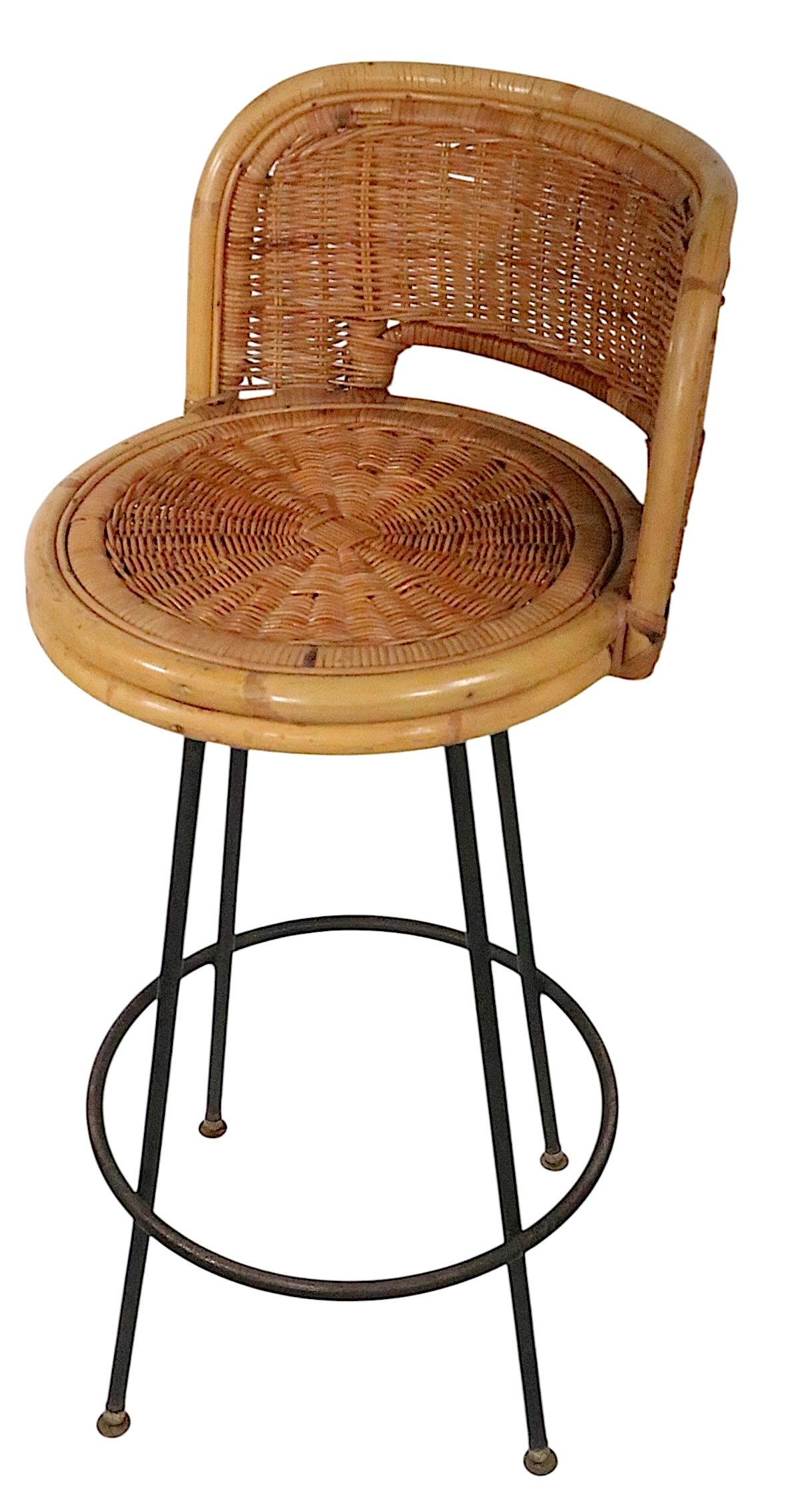 Classic mid century bamboo, wicker and metal swivel bar height stools, attributed to Danny Ho Fong, circa 1950/60's. The stools are in good, original, clean, ready to use condition, showing minor ( inconsequential ) loss to the woven wicker, please
