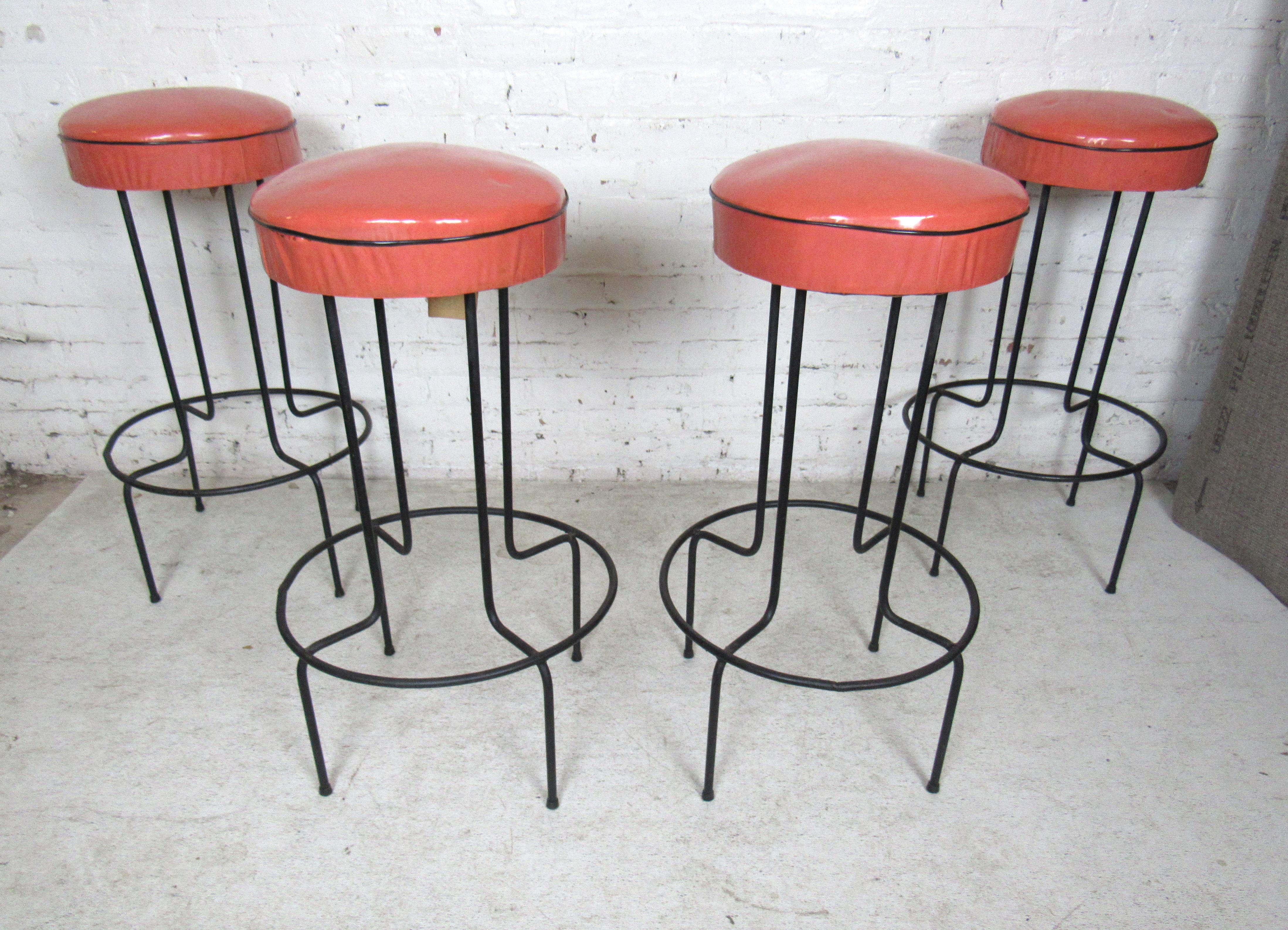 Set of four iron barstools upholstered in a rich salmon colored vinyl. 

Please confirm the item location with the dealer. (NJ/NY).
