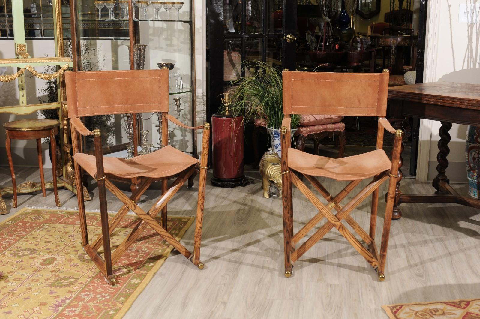 The set of campaign / director armchairs are made by Valenti, a company which started in Barcelona in 1798. The frame is teak with tan suede seats and backs. Solid brass trim
The fact that they fold makes it convenient if you don't want to use them
