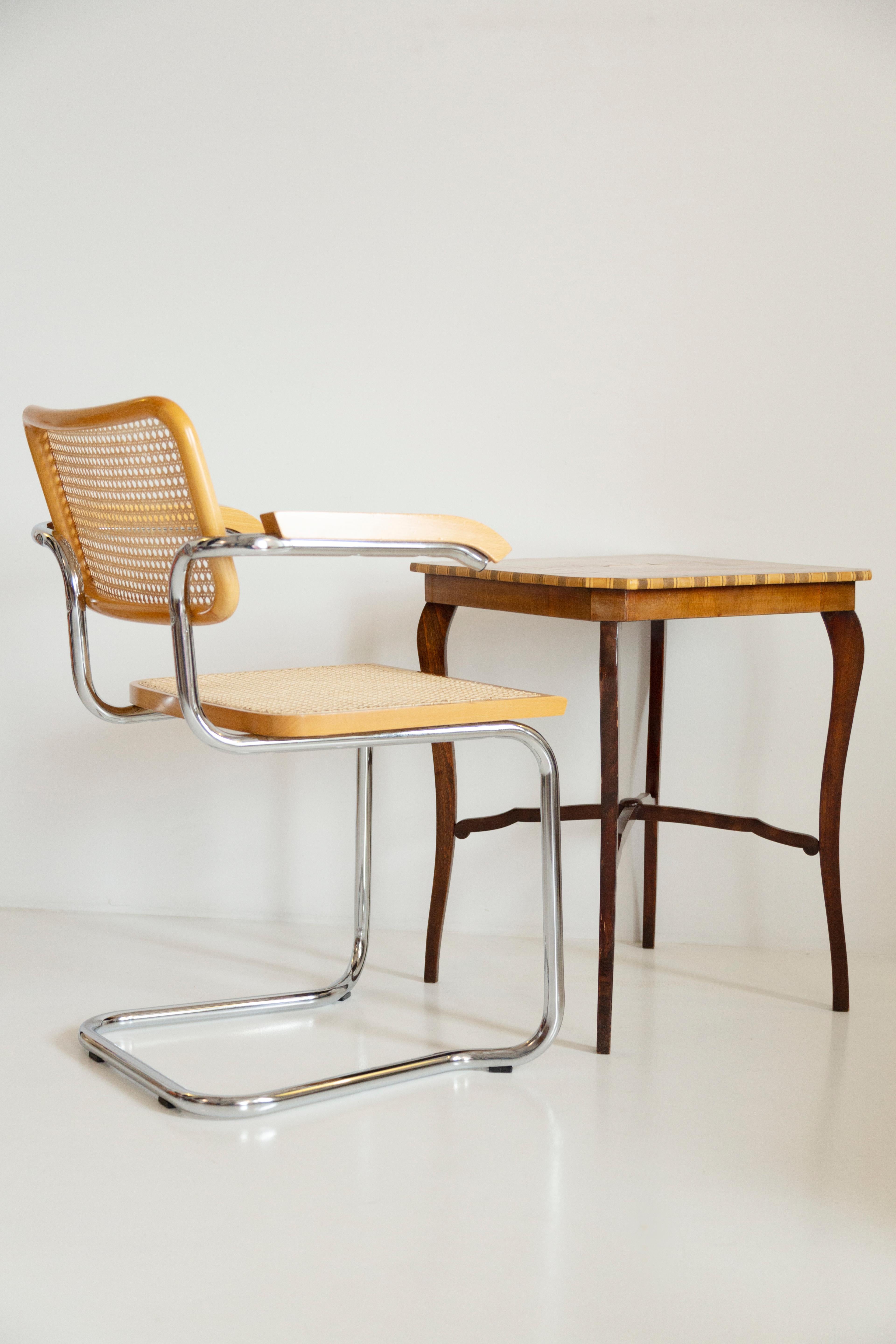 Beautiful midcentury rattan, velvet and wood chair. 

The wonderful and world-famous Cesca chair designed in the 1920s by Marcel Breuer. The Cesca chair is produced by, among others, companies such as Thonet or Knoll; which makes them slightly