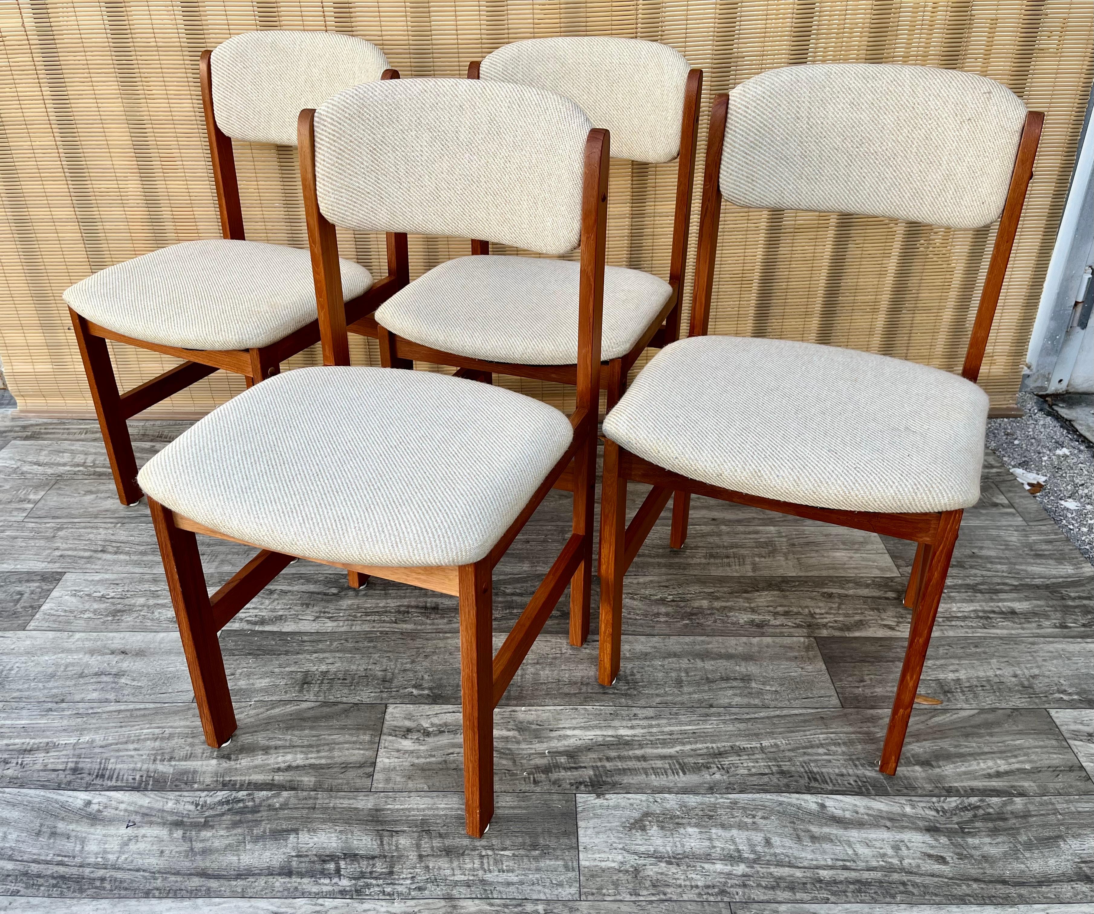 A set of four Vintage Mid-Century Danish Modern Style Dining Chairs by Benny Linden Design. C. 1980s 
Feature a solid teak frame in a minimalist Scandinavian Modern Design, and upholstered seats and back rests with the origin cream color fabric.