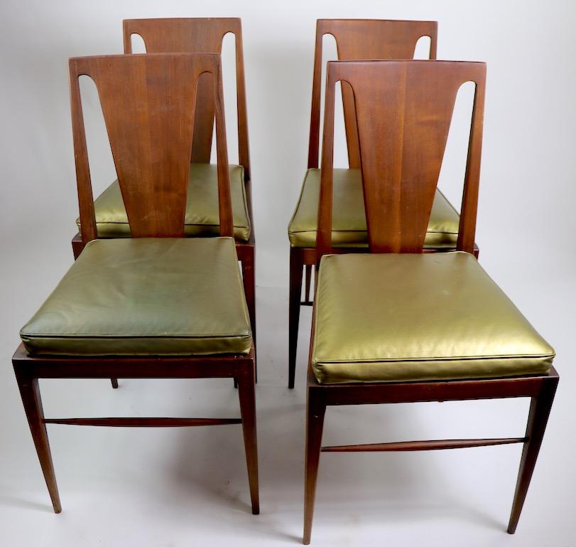 Stylish set of Mid-Century Modern dining chairs, attributed to Harvey Probber. These chairs are solid walnut, with metallic vinyl upholstered seats, wood finish, and upholstered seats, show cosmetic wear. Very well detailed, architectural design,