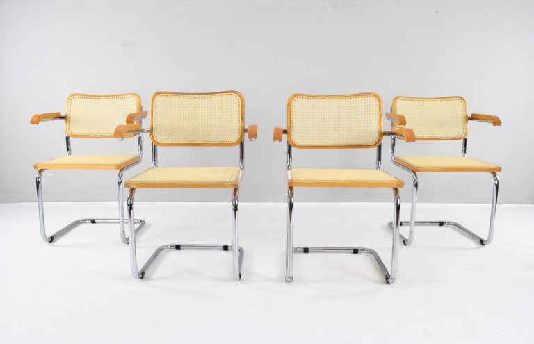 Set of four Cesca chairs model B64, with armrests. Tubular chromed steel structure in good condition. Beech wood frames and natural Viennese grid. All new seat and backrest grids have been fitted.

Dimensions:
Overall height 81cm
Seat height