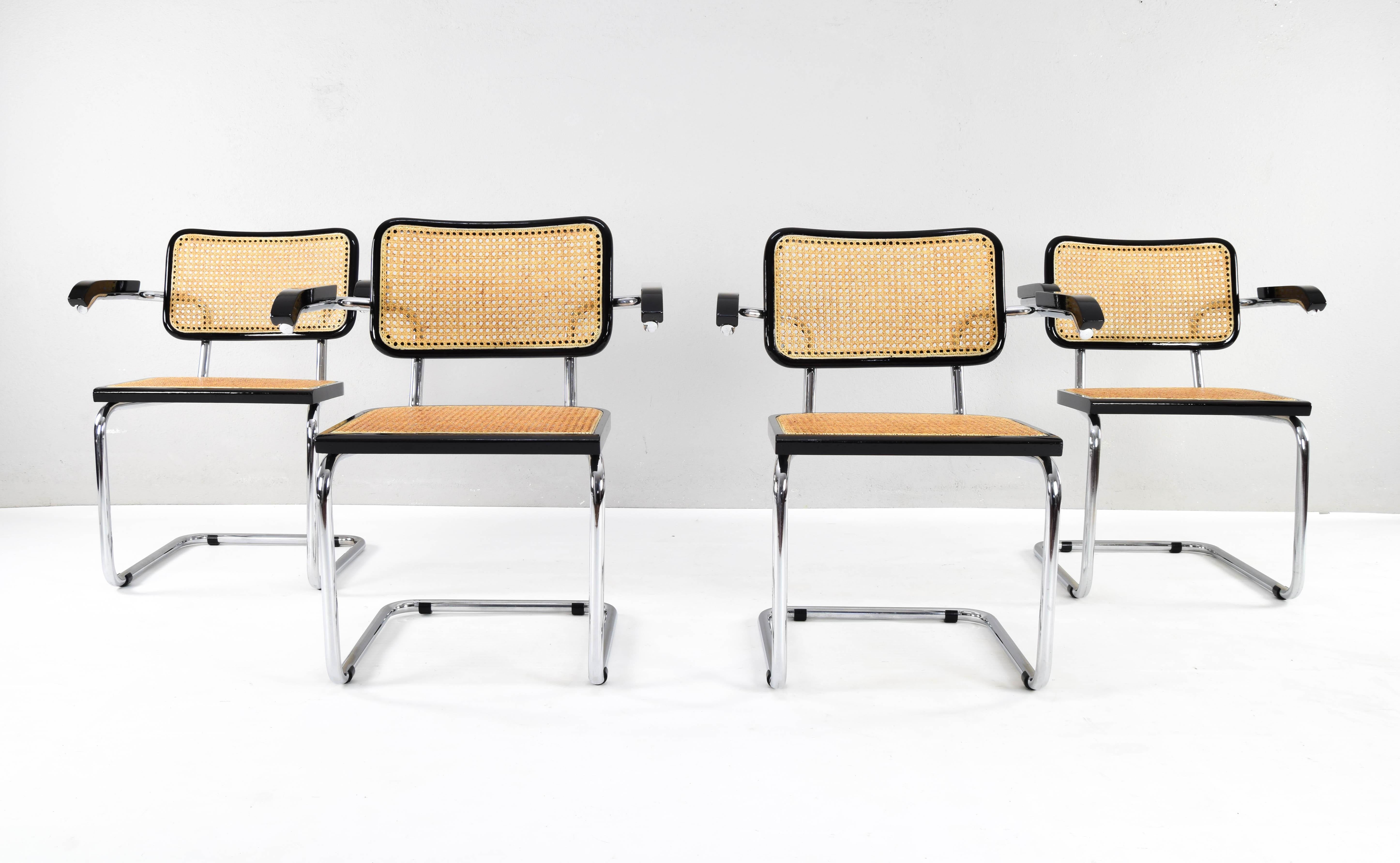 Set of four Cesca chairs model B64, with armrests. The tubular steel chromed structure it is in good condition. Beechwood frames lacquered in black and Viennese natural grid. Grids of the four seats have been put new.

