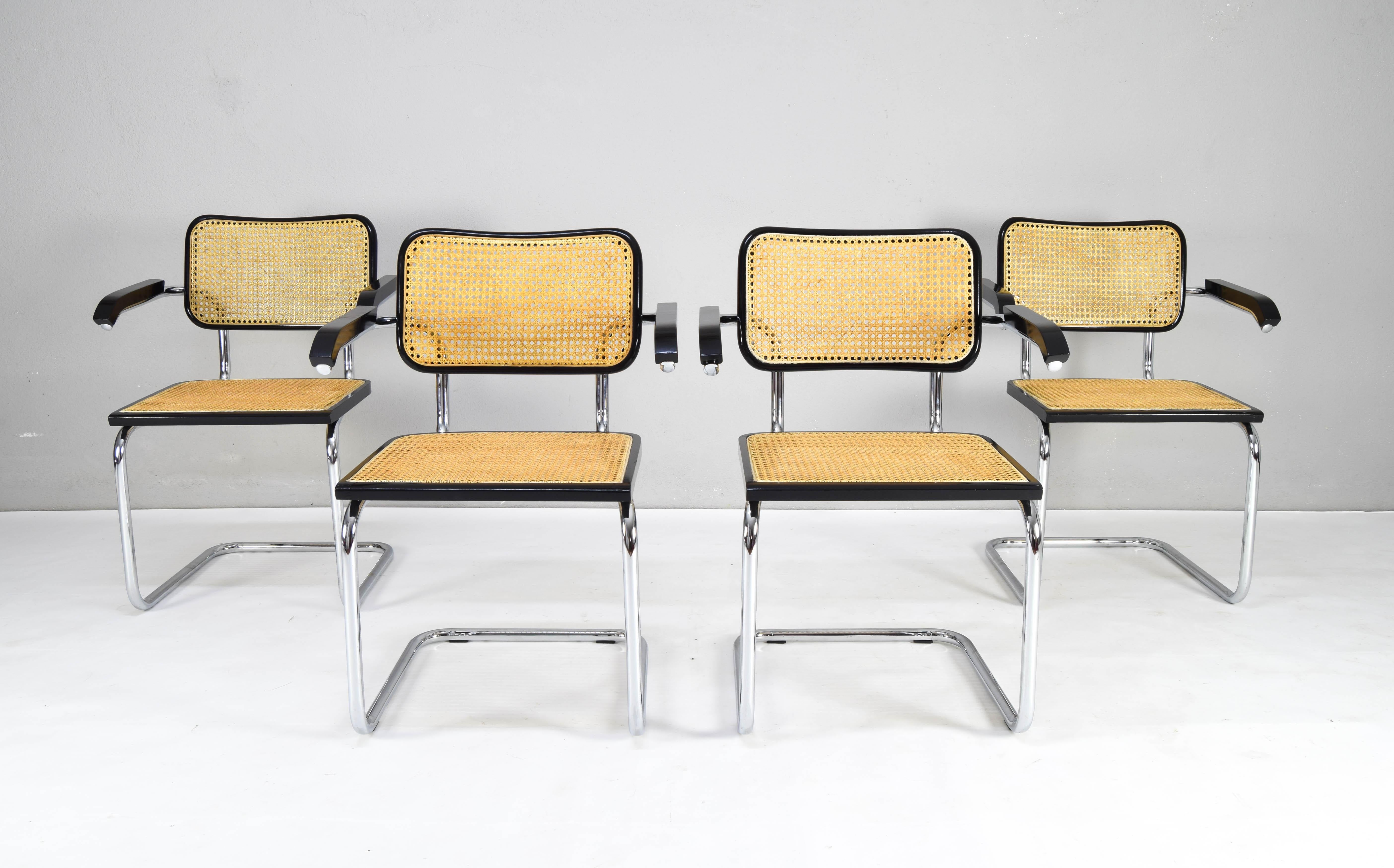 Set of four Cesca chairs model B64, with armrests. 
The tubular steel chromed structure it is in good condition. 
Beechwood frames lacquered in black and Viennese natural grid. 
Grids of the four seats have been put new.

Armrest height: 69.5 cm.