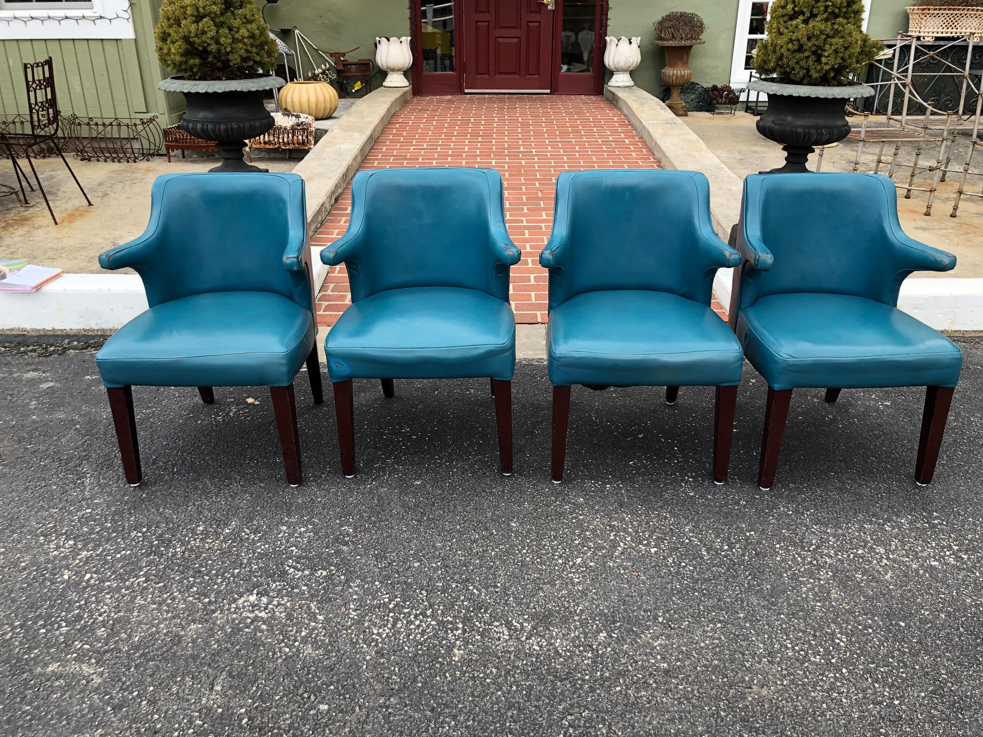 Set of four Mid-Century Modern chairs in peacock blue. These chairs are vinyl and in the style of Hans Wegners papa chair.