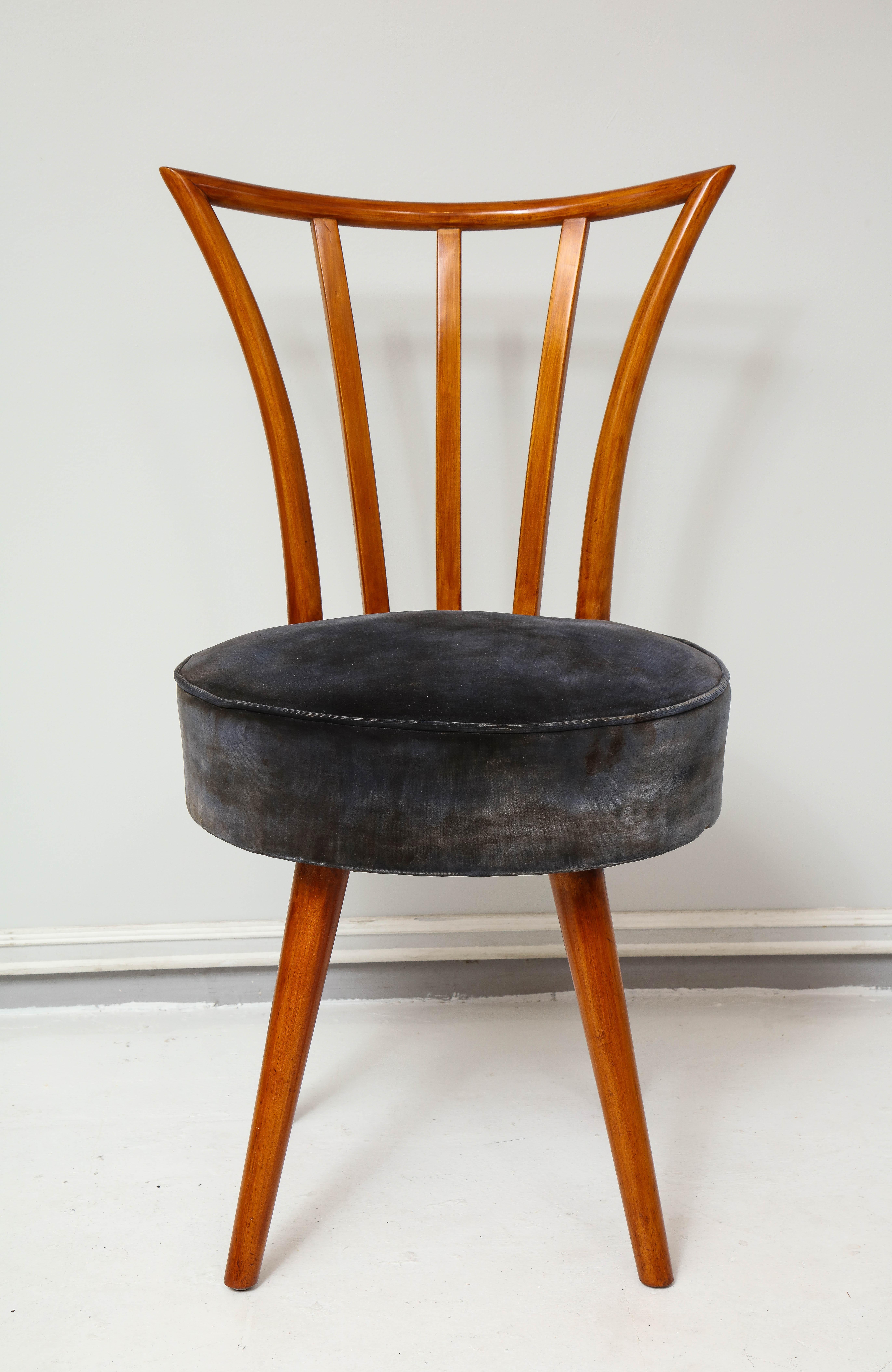 This set of four fabulously chic Mid-Century Modern chairs are reminiscent of chairs designed by the legendary designer, Robsjohn-Gibbings. Please note these chairs swivel.